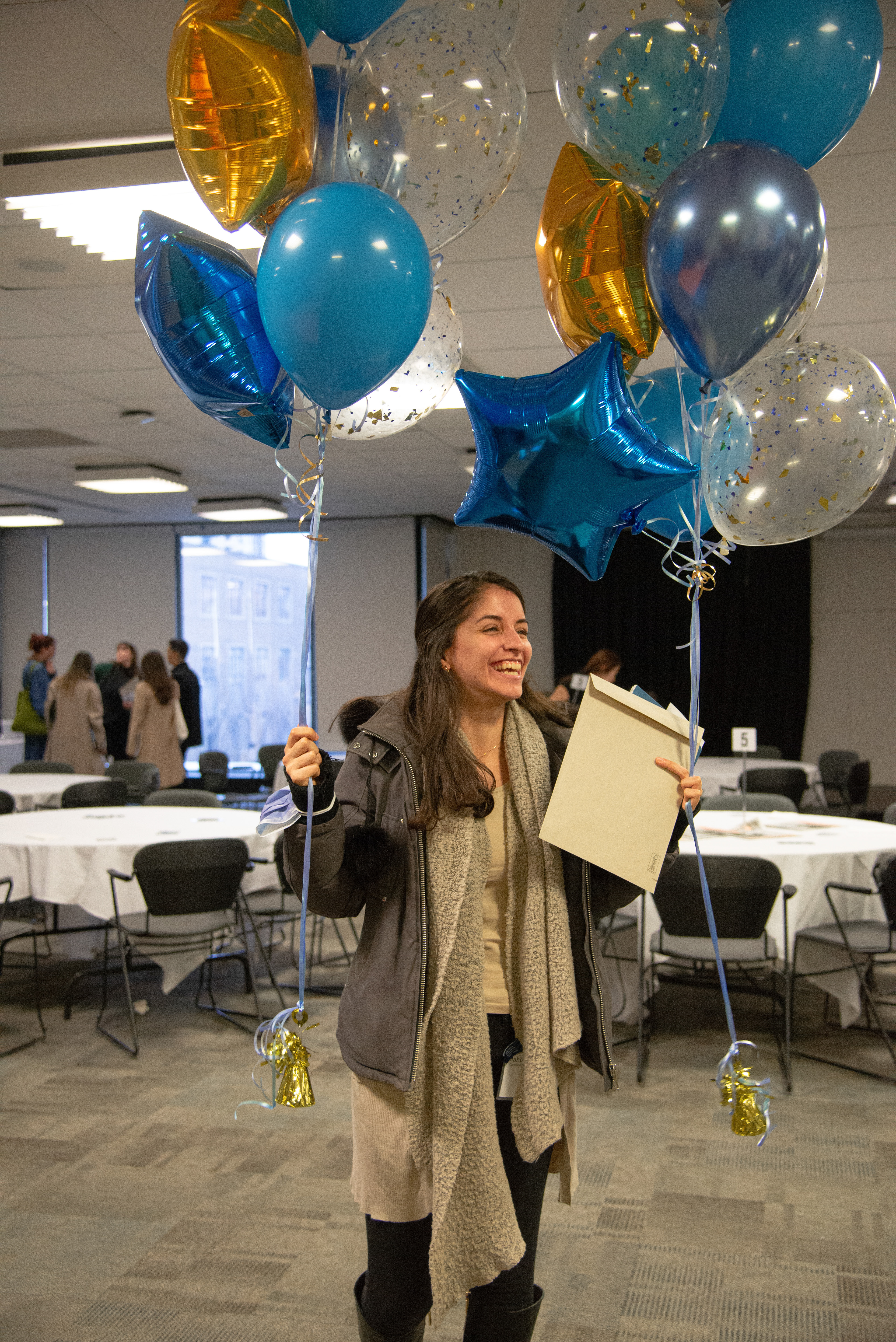 Mahdis Habibinia celebrates her birthday with an award and balloons from the School of Journalism award ceremony on Nov. 28, 2022. (Aloysius Wong)