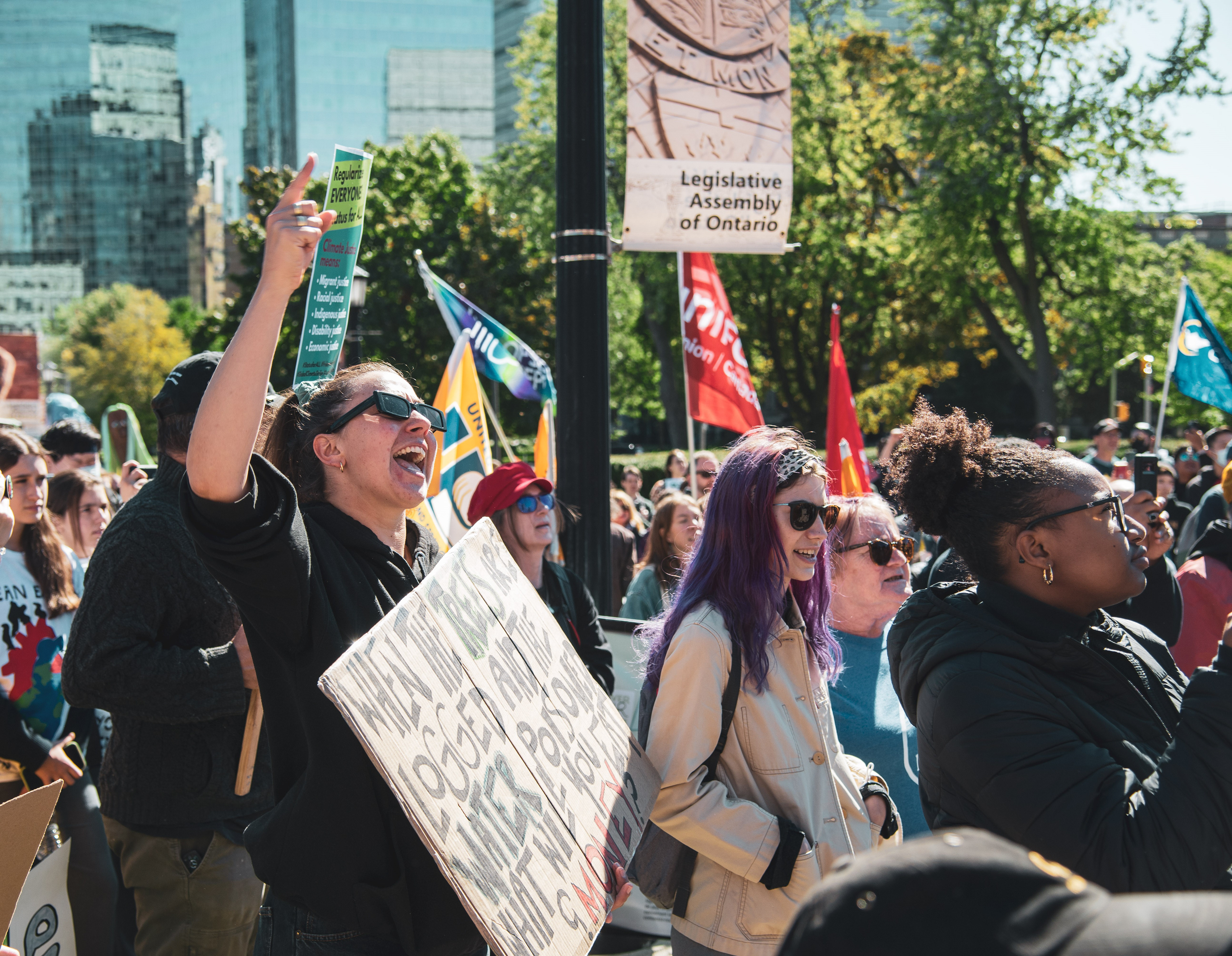 A demonstrator holds a protest sign while joining a chant at the climate rally.