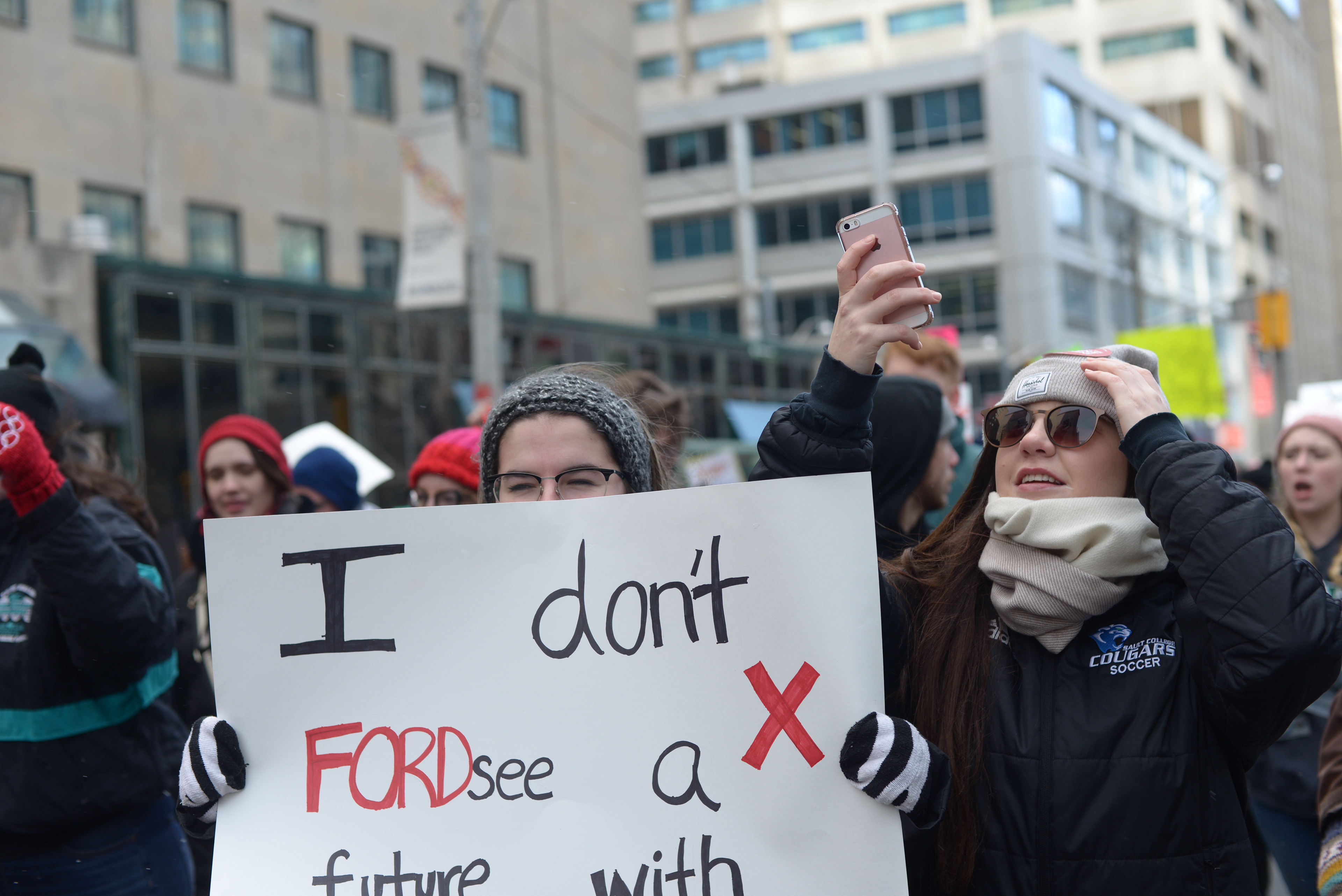 photo of a young woman holding a sign that reads "I don't FORDsee a future with..." at the January 25, 2019 OSAP Protest