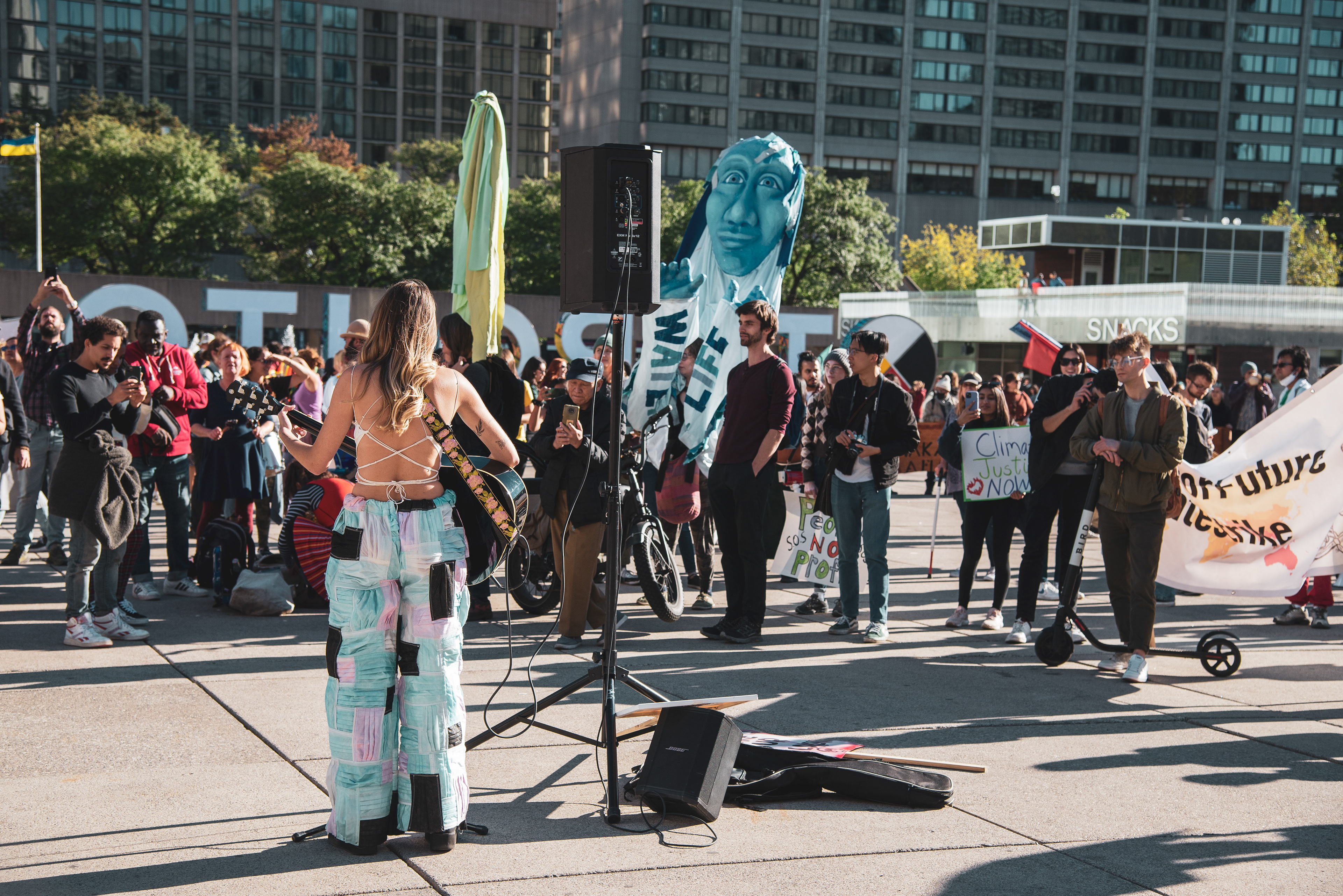 Layla Staats, a Mohawk filmmaker, speaker, and activist, performs at Nathan Phillips Square at the end of the march.