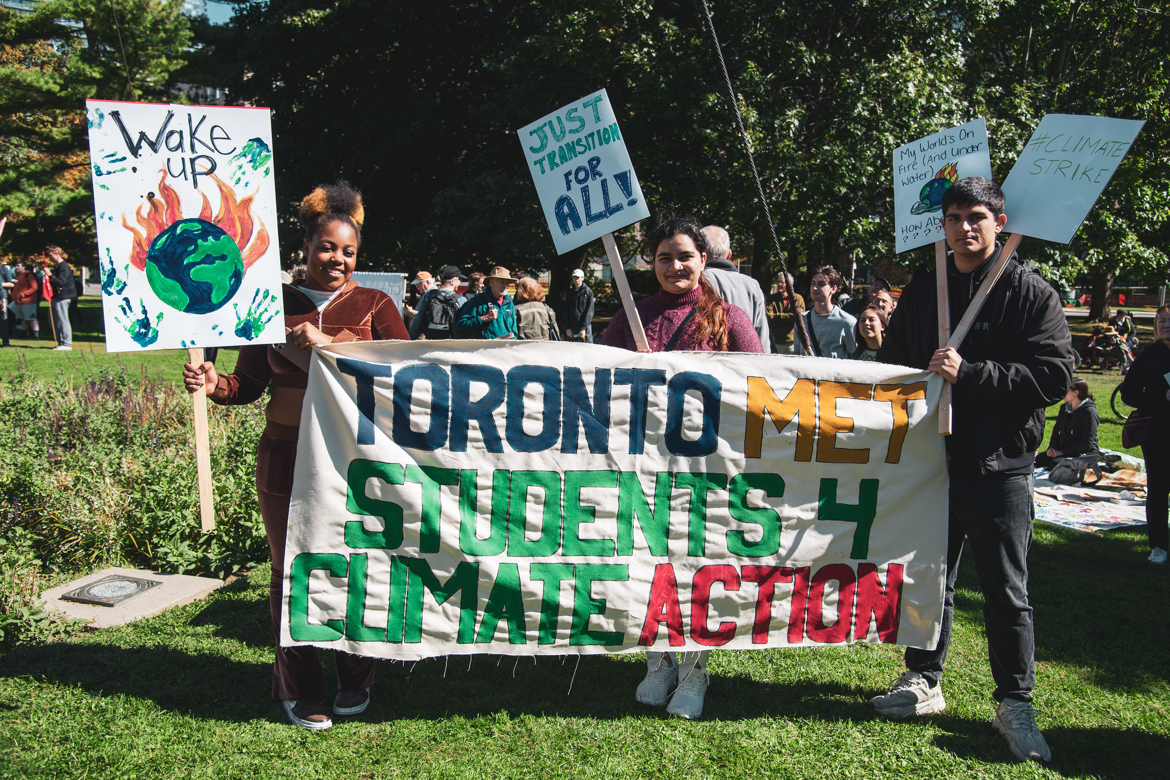 Students from Toronto Metropolitan University join the climate rally in Queen's Park.