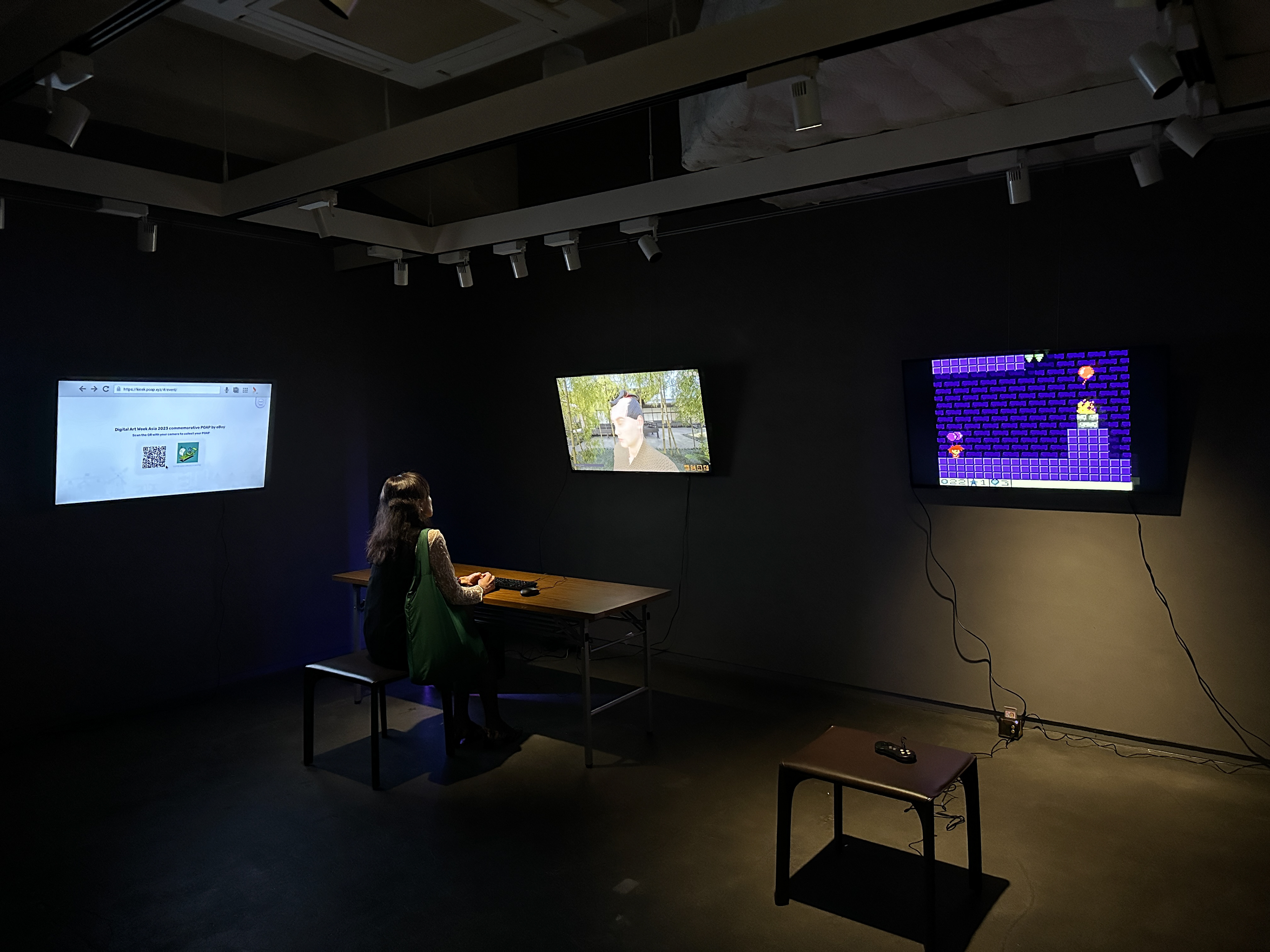 From left to right: A free NFT station for attendees, a Web 3.0 high fidelity immersive game is placed beside a customised retro gameboy title