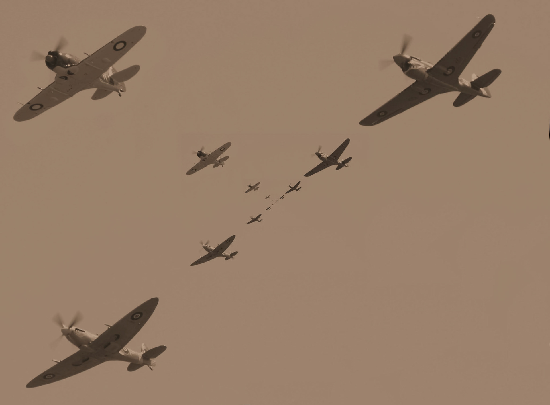 A sepia-toned image shows several warplanes flying in formation against a clear sky, showcasing historical aircraft.