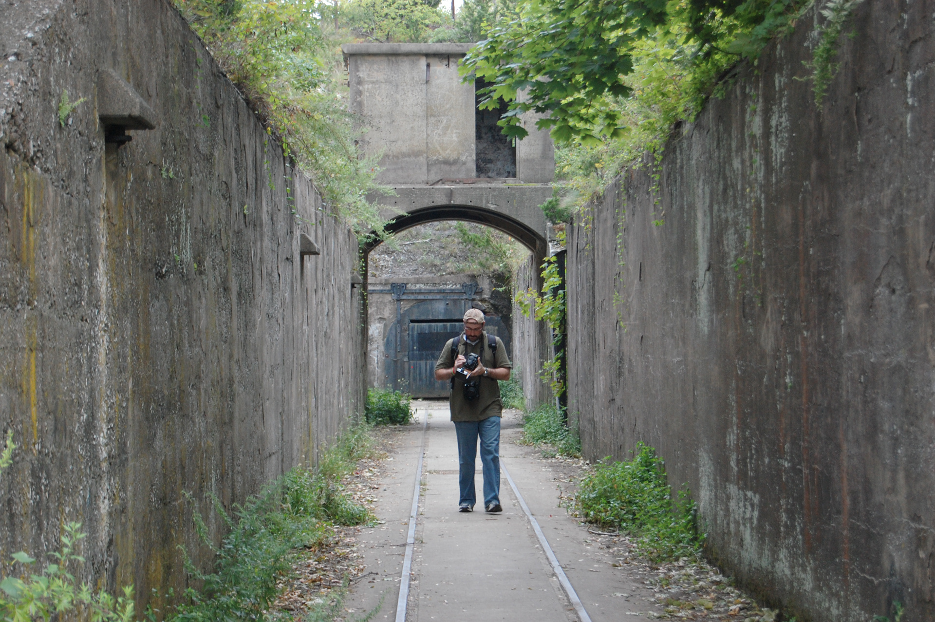 Lu walking and adjusting a camera
