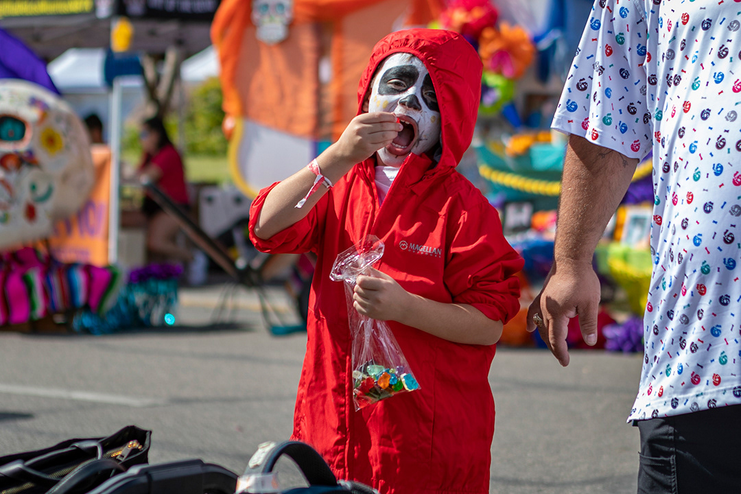 Henry Cantu, 5, eats gummy bears while dressed as Miguel, a character from Disney's Coco, during the New Braunfels Dia de los Muertos Festival on Oct. 19, 2024. BLAINE YOUNG | Herald-Zeitung
