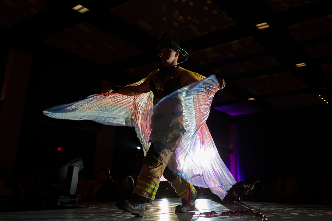 Bobby Dallimore walks the stage while modeling a bra honoring Wendy Parker during Bras for a Cause at the New Braunfels Civic/Convention Center on Oct. 3, 2024. BLAINE YOUNG | Herald-Zeitung