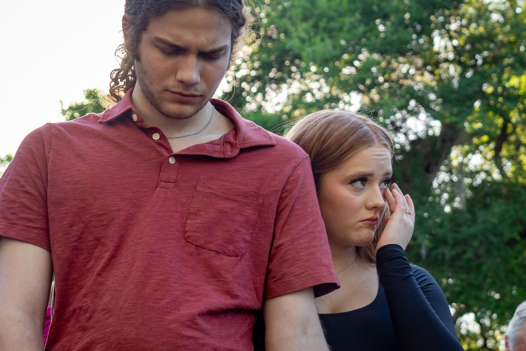 Ellee Carlisle (right) wipes away tears during a vigil held for Caleb Harris, the missing Corpus Christi college student from New Braunfels, on April 4, 2024 in Landa Park. Carlisle and Tristen Parker (left) are both friends of Harris. BLAINE YOUNG | Herald-Zeitung