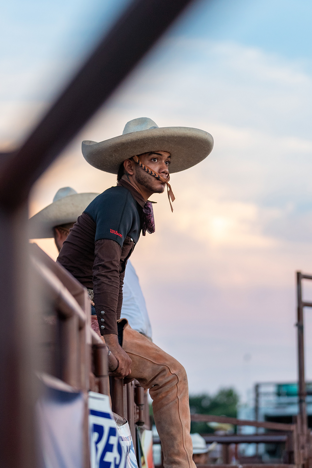 Angel Cornejo sits on top of a chute gate during the 13th annual Gran Charreada at the Diaz Ranch on July 27, 2024. BLAINE YOUNG | Herald-Zeitun