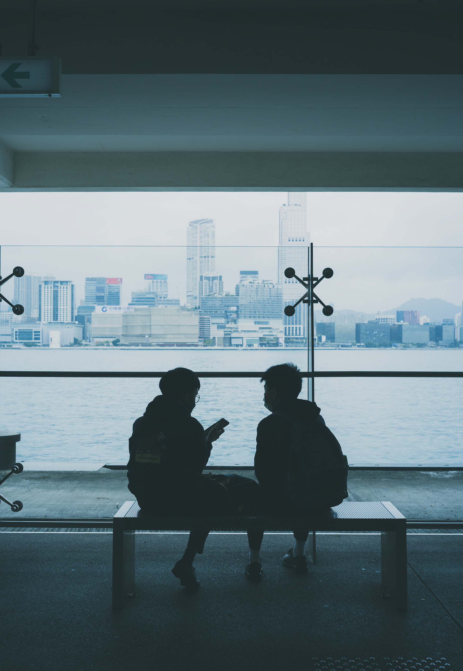 2 students were waiting for ferry to Tsim Sha Tsui [Panasonic LUMIX DC-S5, LEICA Summicron-M 35mm f/2 ASPH]