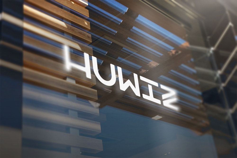 The company name "HUWIZ" written on a building window. The company name is displayed all white