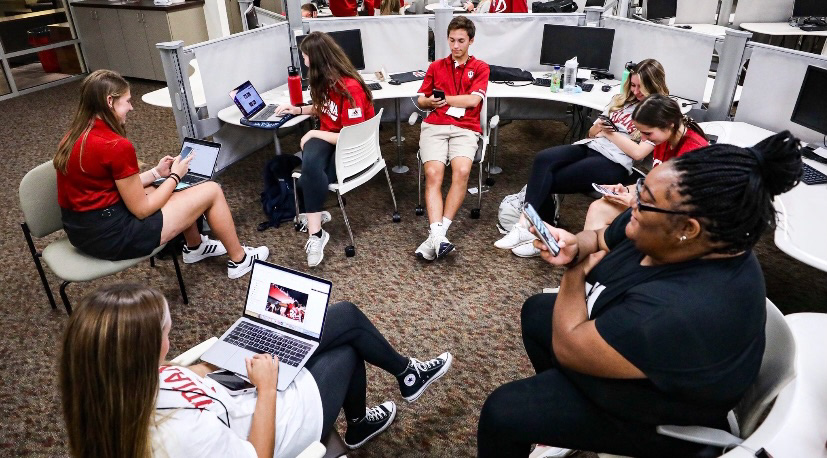 The social media team working at posting content during the football games.