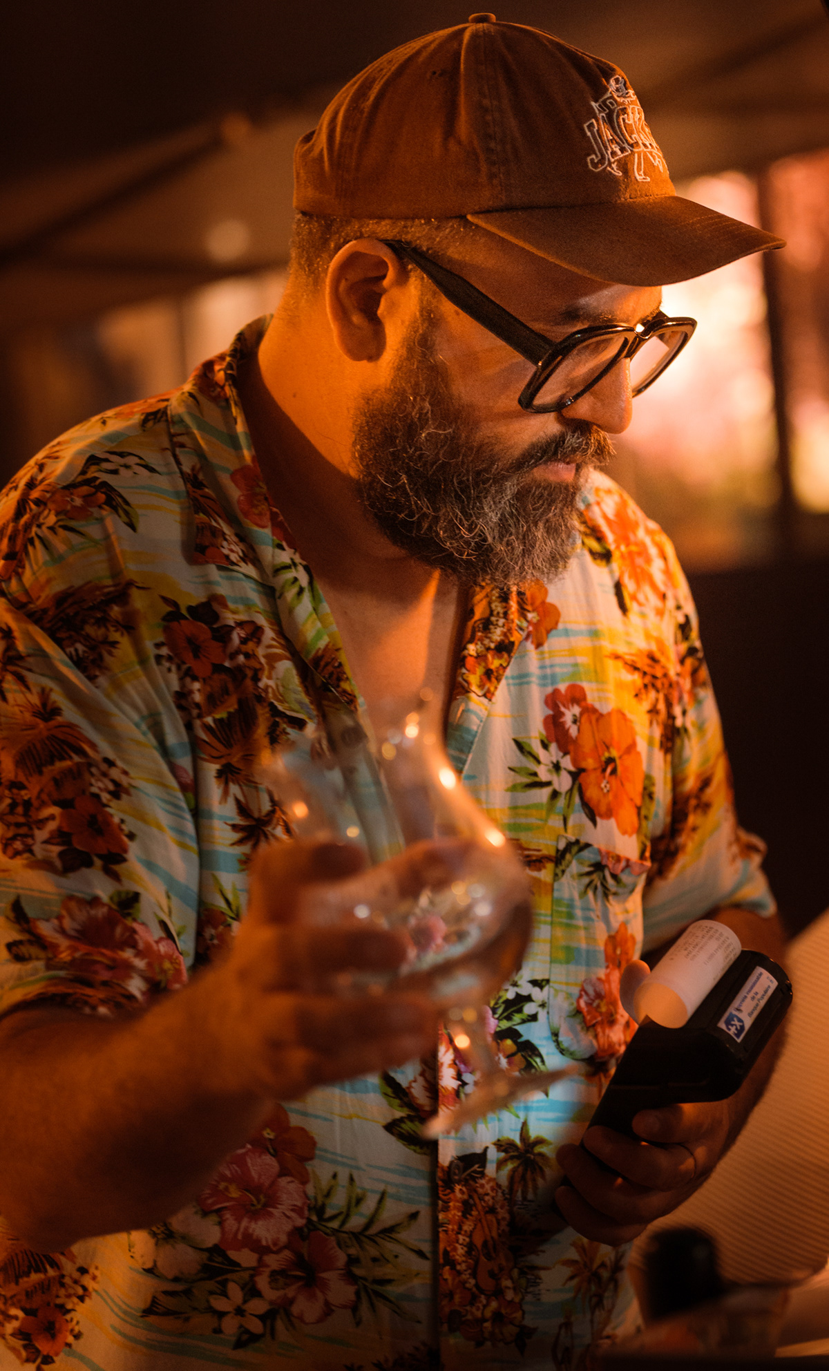 Barman à la chemise hawaïenne préparant un verreà La Chistera pendant la Fête de la Musique