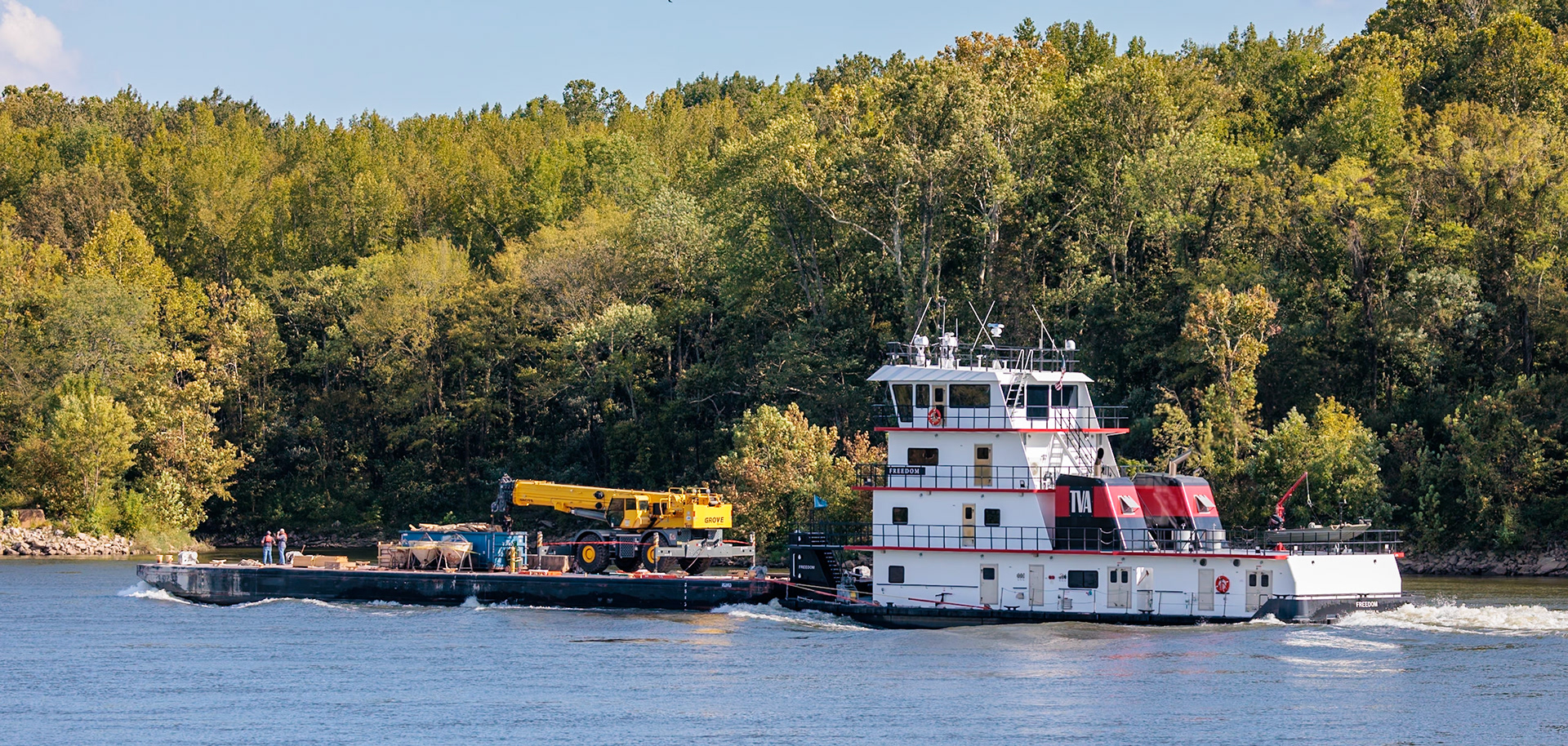 230917_020 Tennessee Valley Authority tug boat "Freedom" pushing a barge with construction equipment upstream on the Tennessee River near Counce, Tennessee