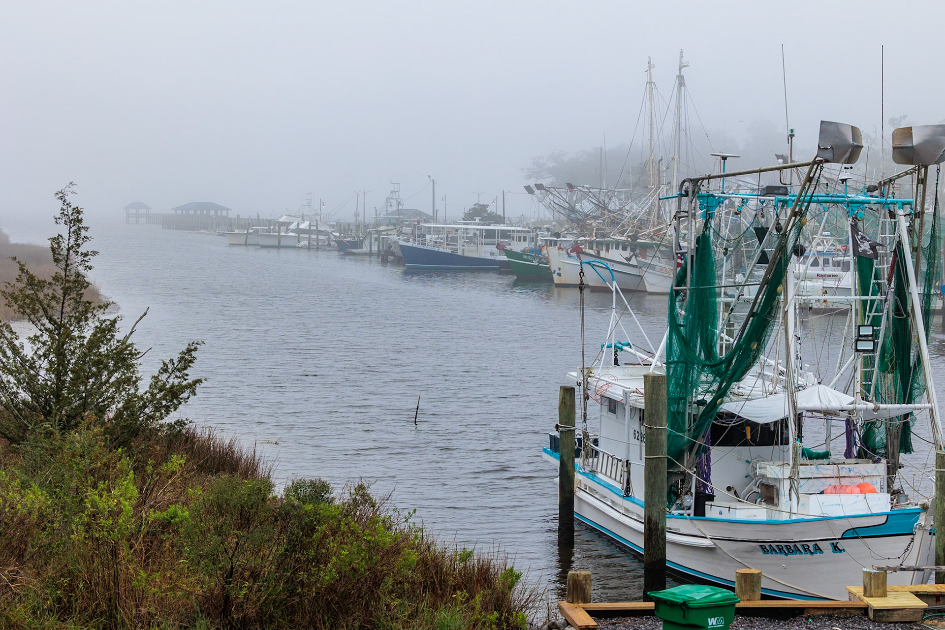 211231_007 Commercial fishing boats in the harbor at Ocean Springs, Mississippi on a foggy morning