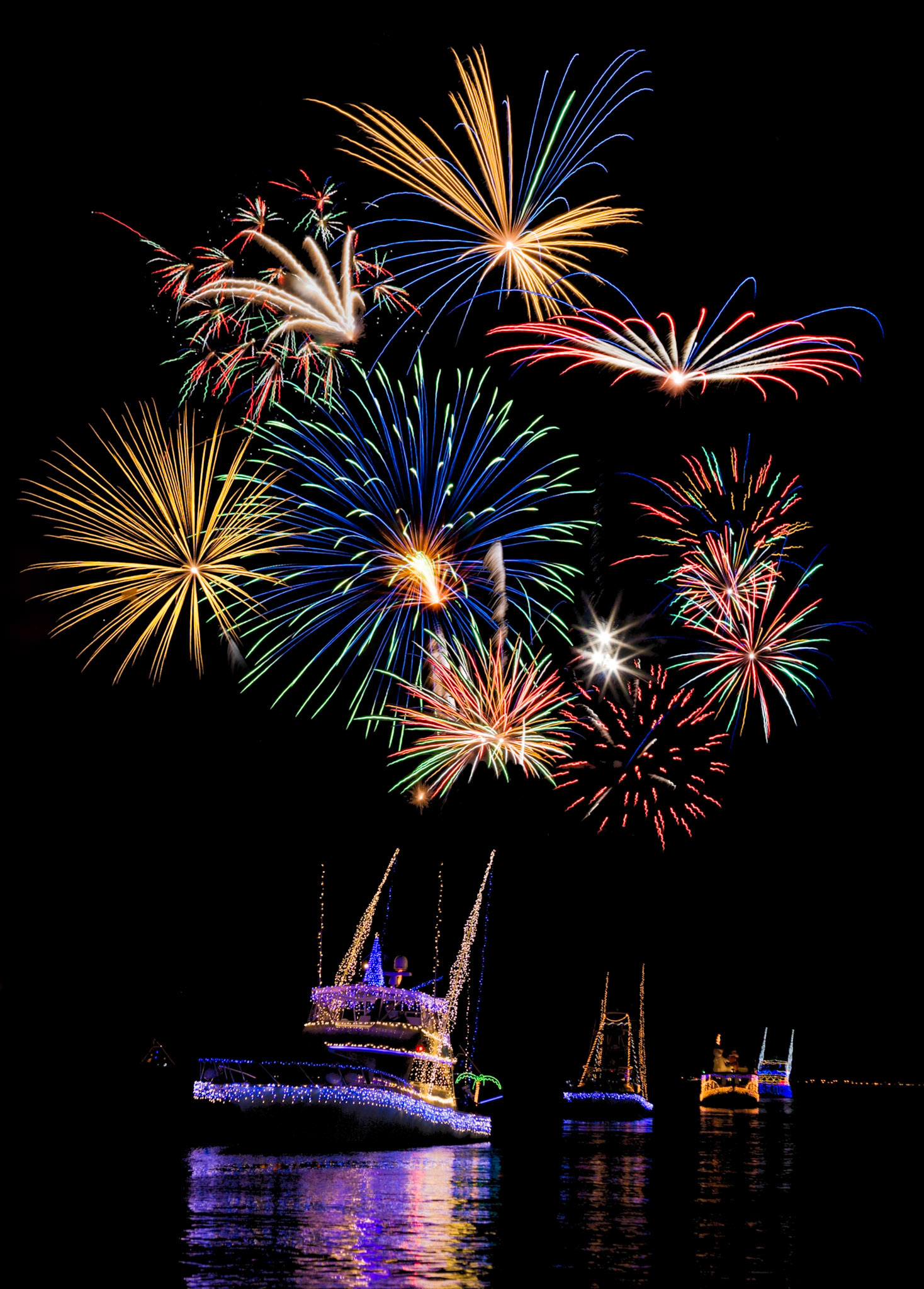 141205 Biloxi Boat Parade - Composite image of Christmas boat parade in Biloxi, Mississippi and July 4th fireworks in Gulfport, Mississippi