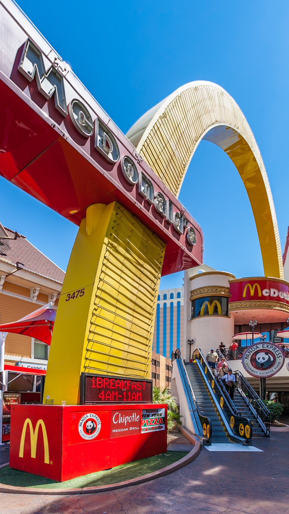 140502_644 Tourists ride the escalator under the McDonald's trademark golden arches on the Las Vegas Strip in Paradise, Nevada