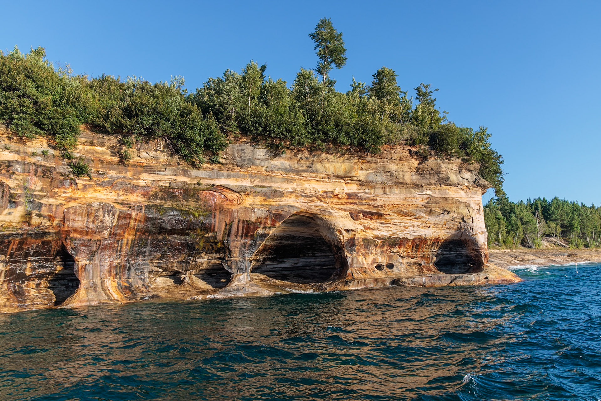 250826_151 Shallow caves in the sandstone cliffs along the Pictured Rocks National Lakeshore near Munising, Michigan, USA