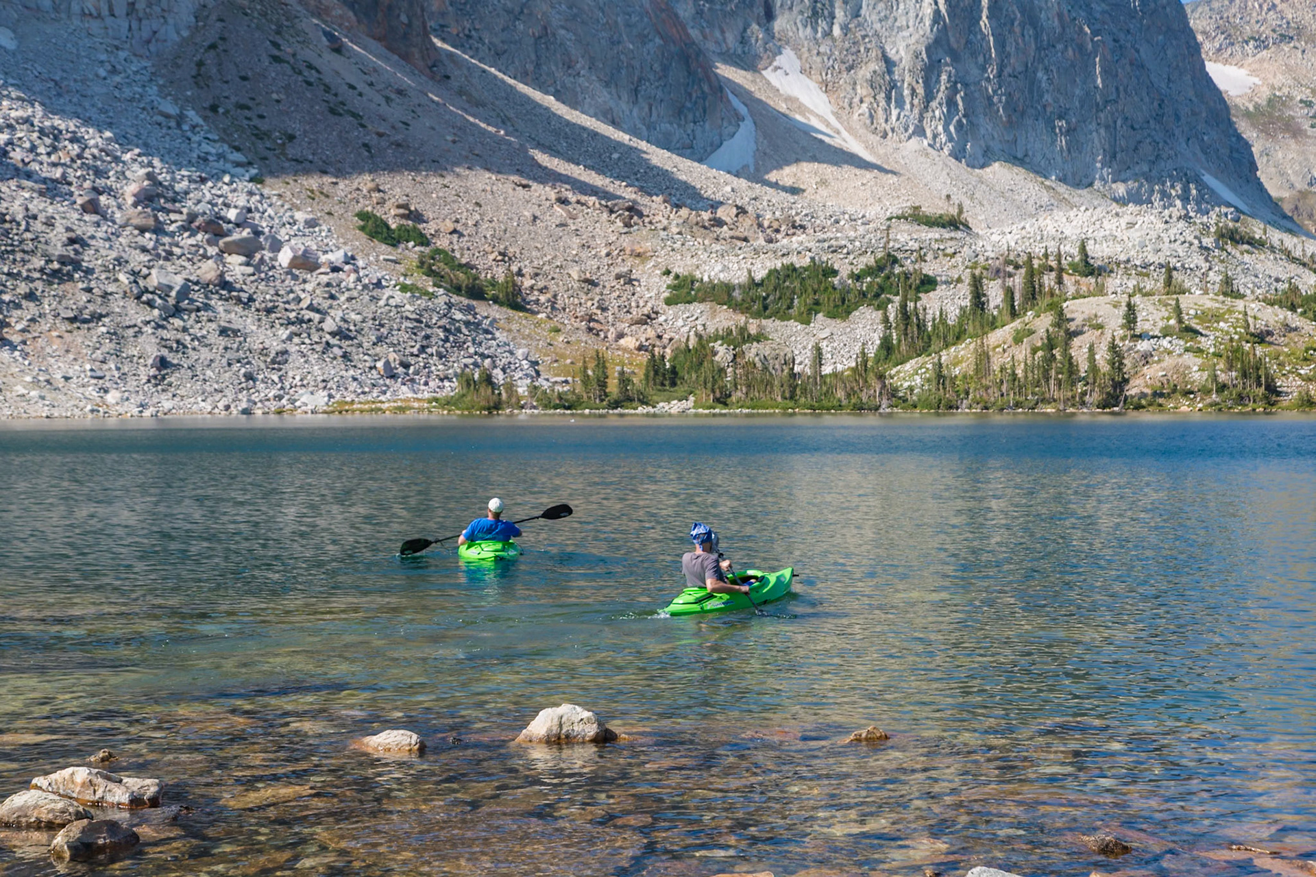 180811_334 Two young men prepare for kayaking along the rock shoreline of Lake Marie in the Snowy Range area of Medicine Bow National Forest in Wyoming