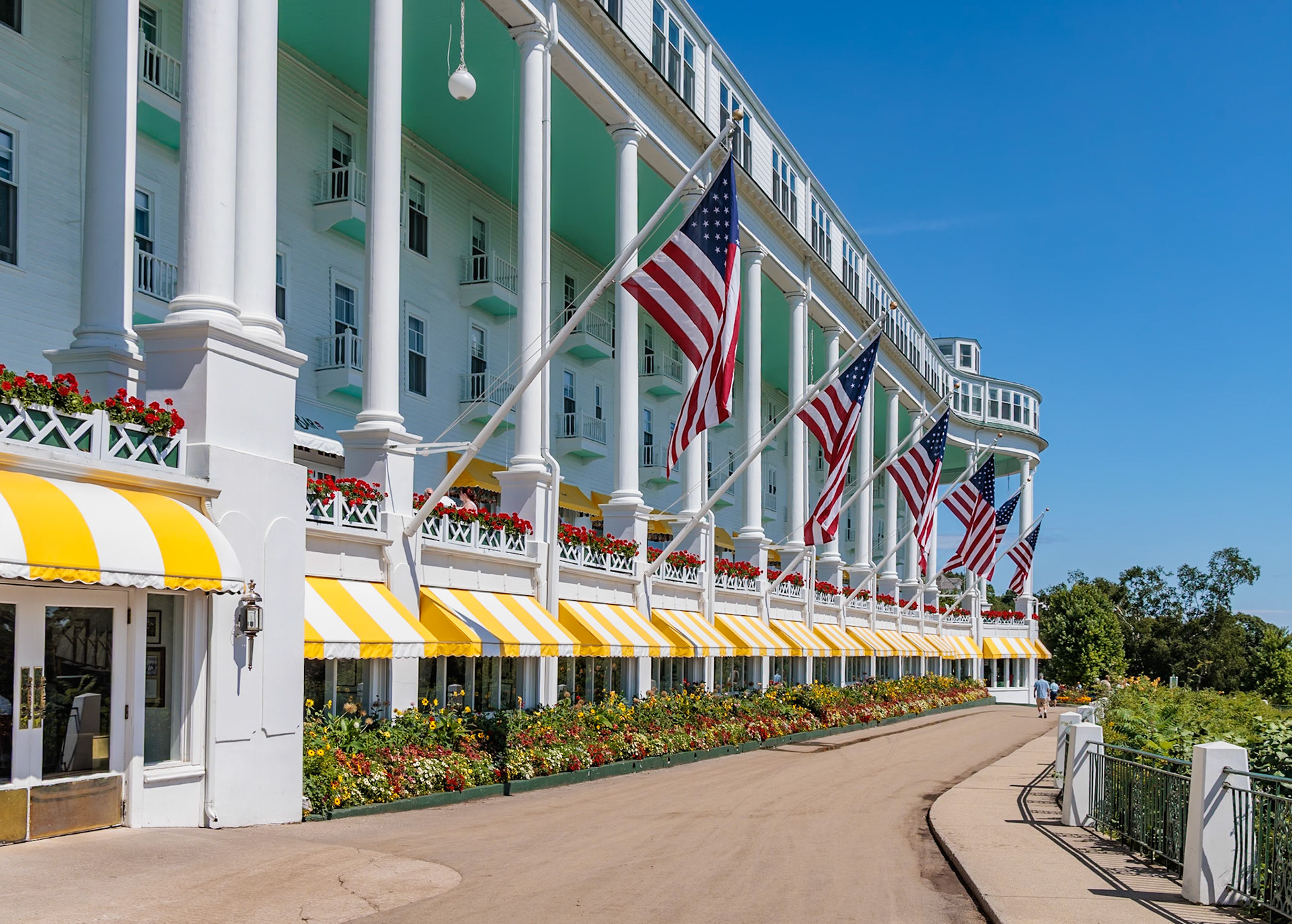 250821_162 American flags flying alongside the "Worlds Longest Porch" at the Grand Hotel on Mackinac Island, Michigan, USA