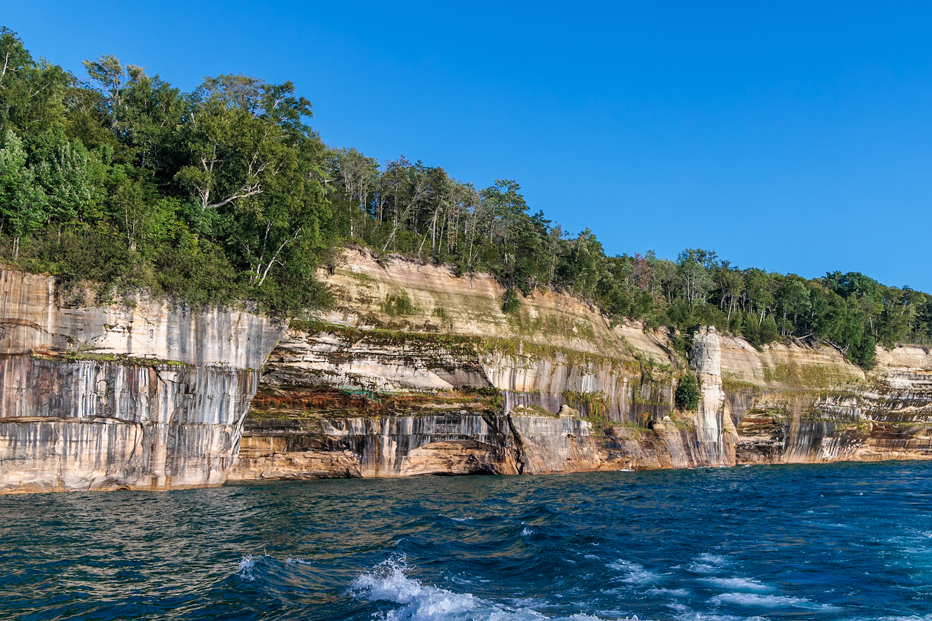 250826_188 Mineral deposits form colorful patterns on the sandstone cliffs along the Pictured Rocks National Lakeshore of Lake Superior near Munising, Michigan, USA