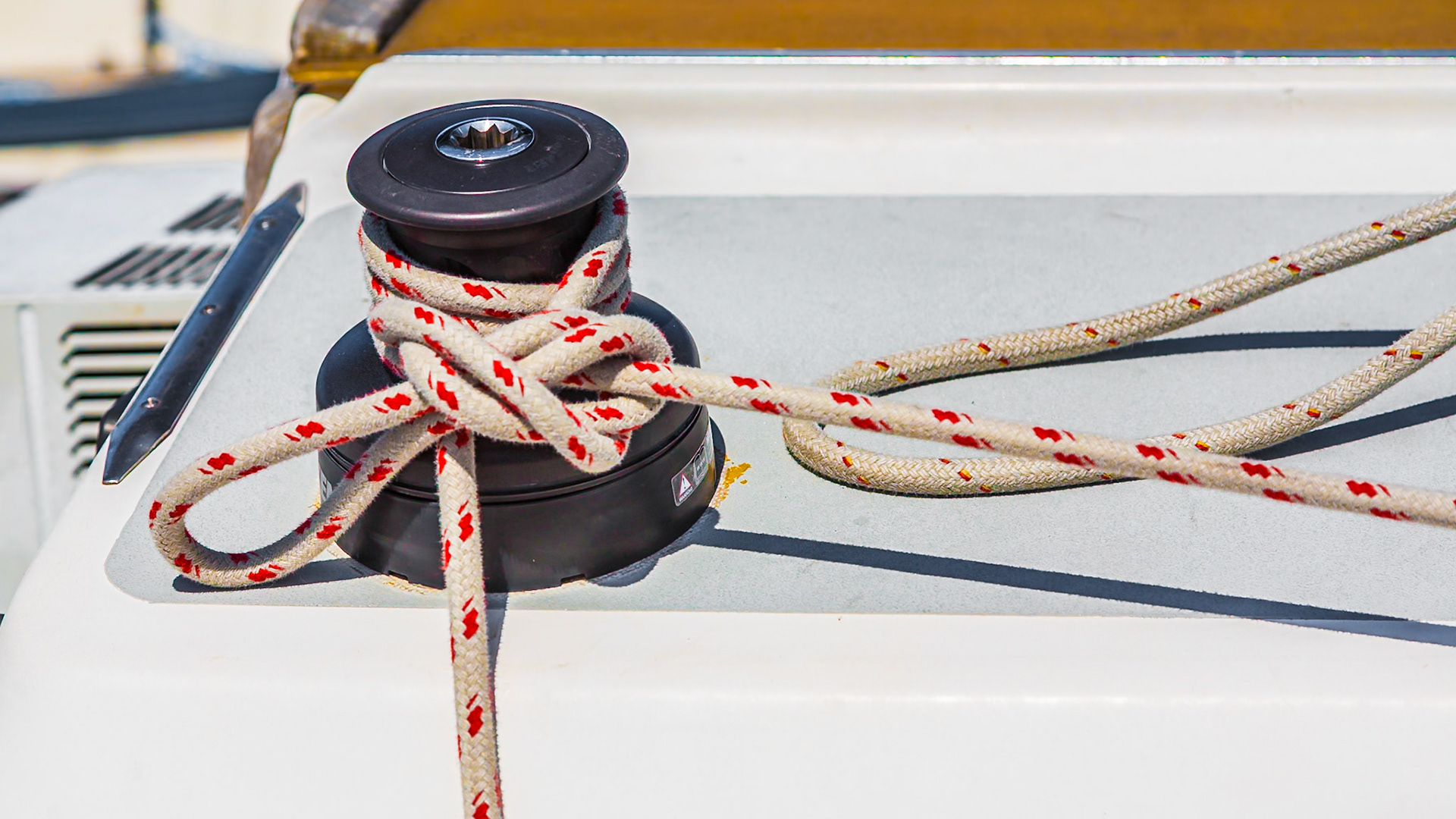 140617_531 Line tied to winch holds secures sailboat in slip at the Gulfport Yacht Club in the Gulfport Municipal Harbor in Gulfport, Mississippi