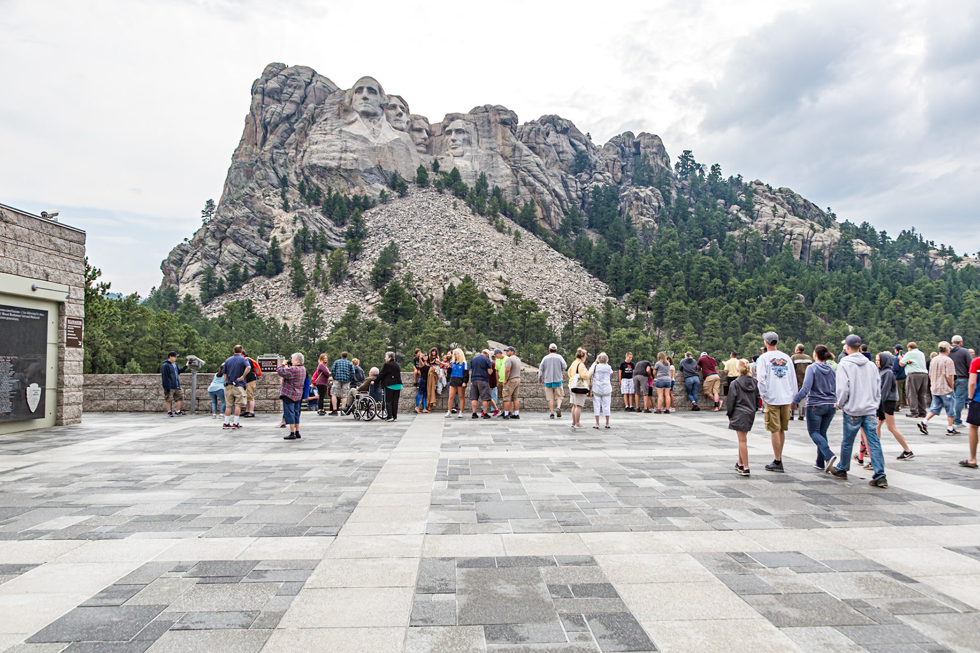 180814_080 Park visitors admire the carved granite busts of George Washington, Thomas Jefferson, Theodore "Teddy" Roosevelt and Abraham Lincoln from the Grand View Terrace at Mount Rushmore National Monument near Keystone, South Dakota