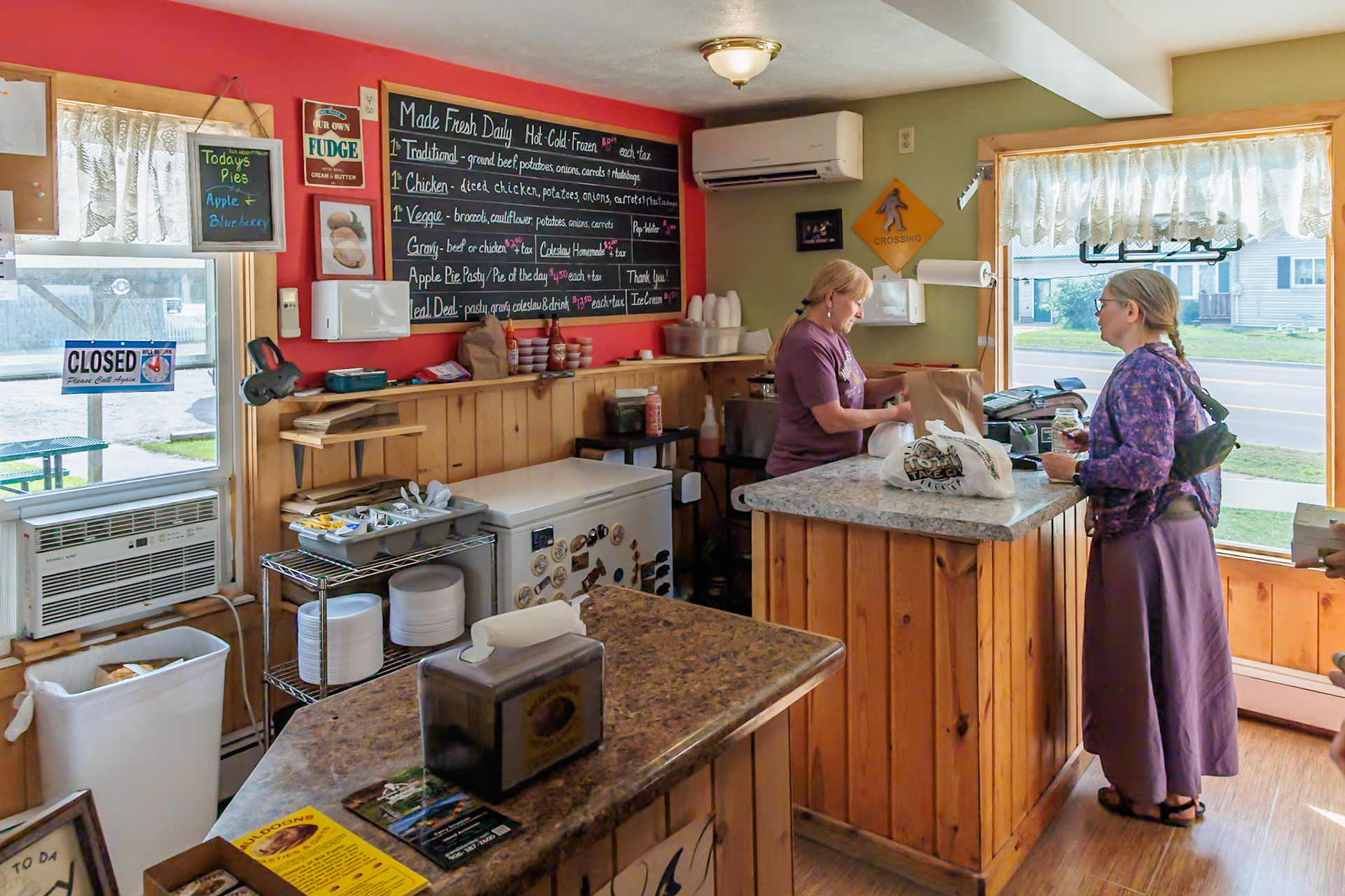 250825_175 Woman purchasing Cornish pasties at Muldoons Pasties and Gifts in Munising, Michigan, USA