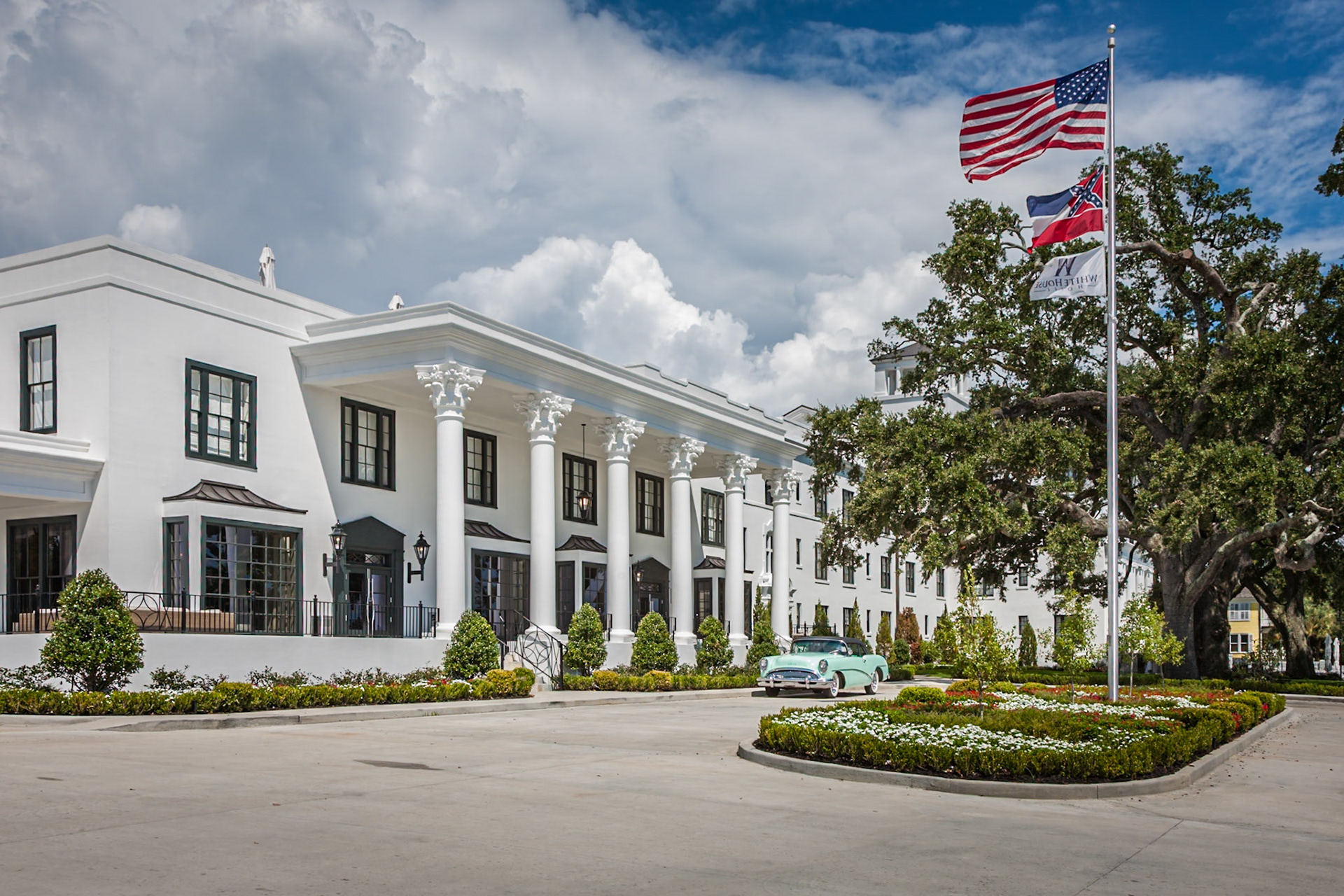 140910_115 Classic 1954 Buick Skylark and US and Mississippi flags in front of restored historic White House Hotel in Biloxi, Mississippi