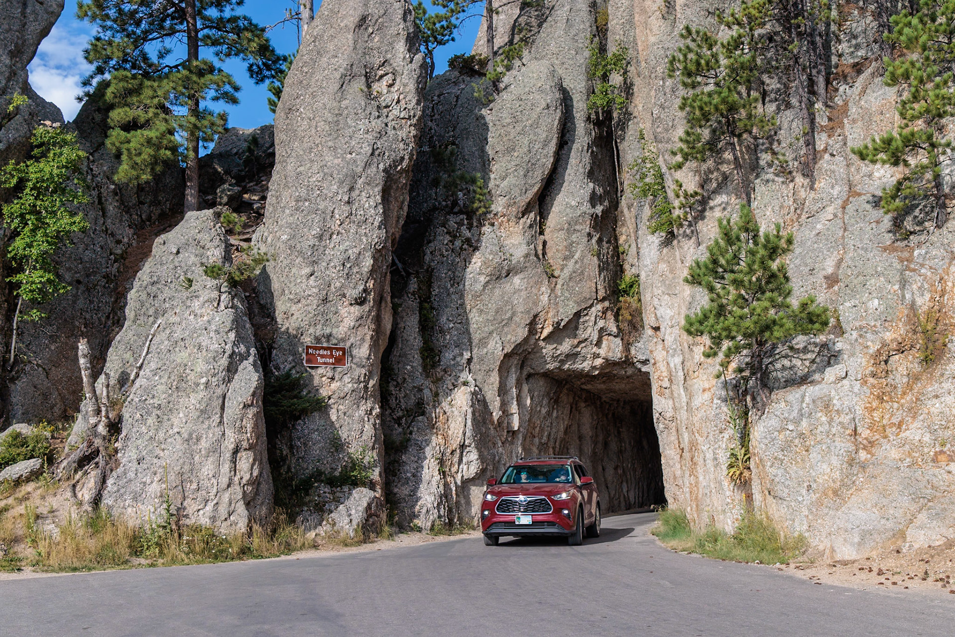 240821_082 SUV exiting the Needles Eye Tunnel in Custer State Park, South Dakota, USA