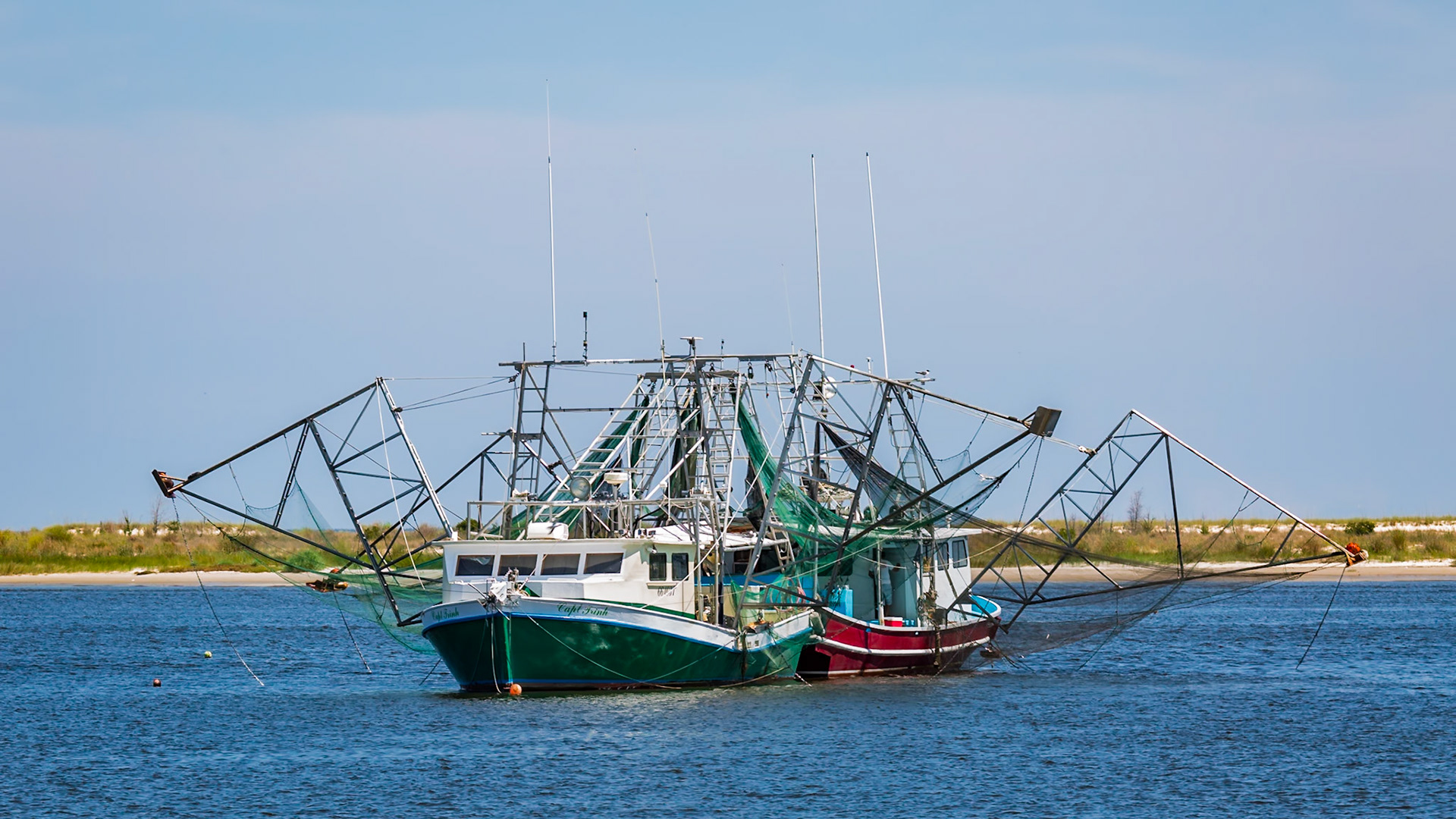 160701_141 Two commercial shrimp boats tied together and moored off the beach in Biloxi, Mississippi