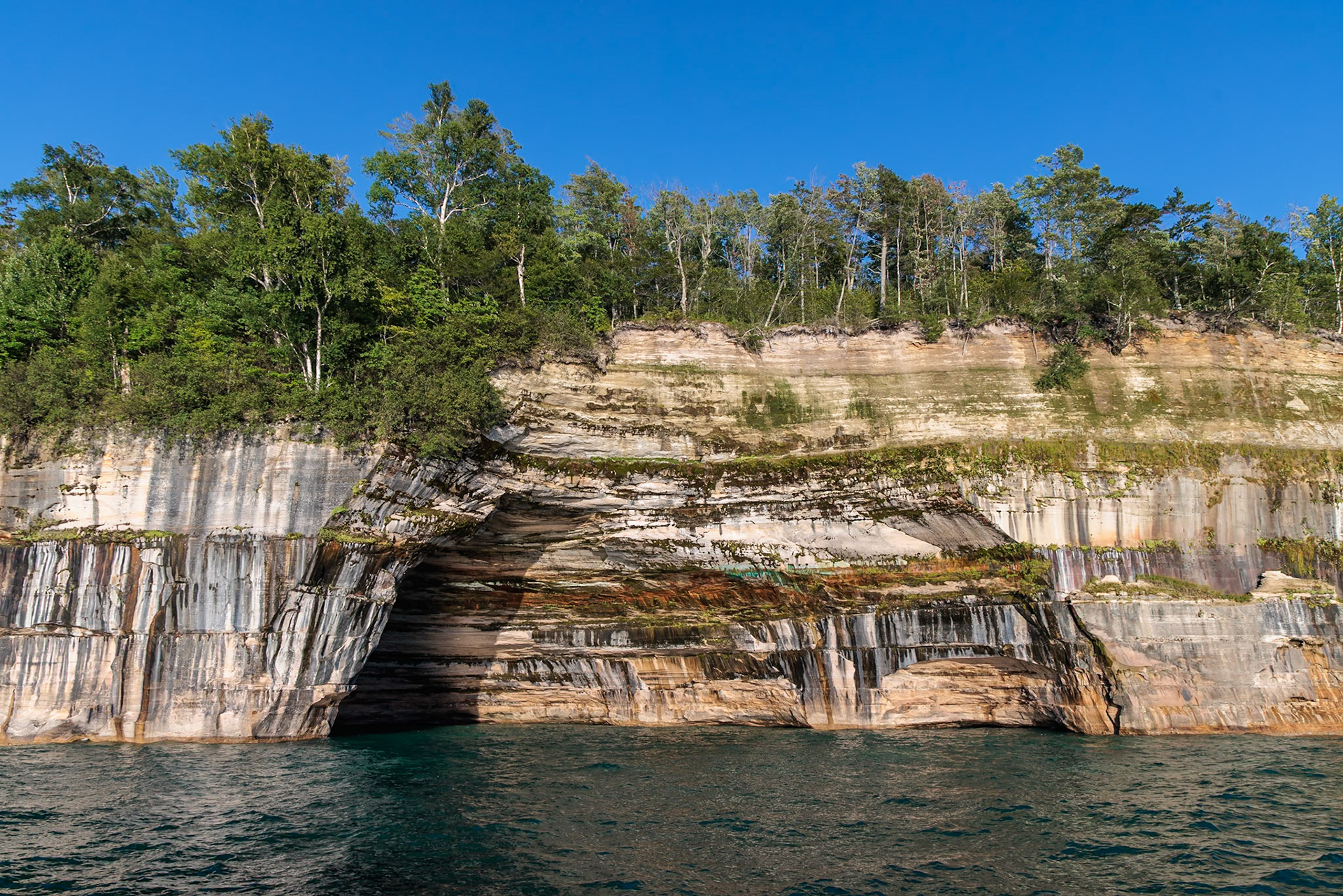 250826_182 Mineral deposits form colorful patterns on the sandstone cliffs along the Pictured Rocks National Lakeshore of Lake Superior near Munising, Michigan, USA