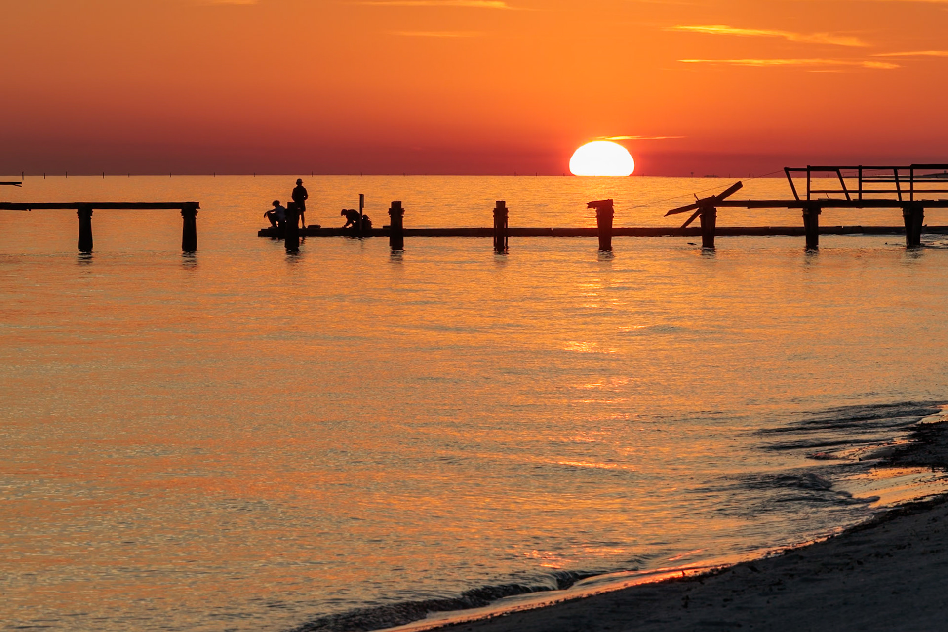 220114_210 Sunset behind dilapidated fishing pier damaged by hurricanes on the Mississippi Gulf Coast in Long Beach, Mississippi