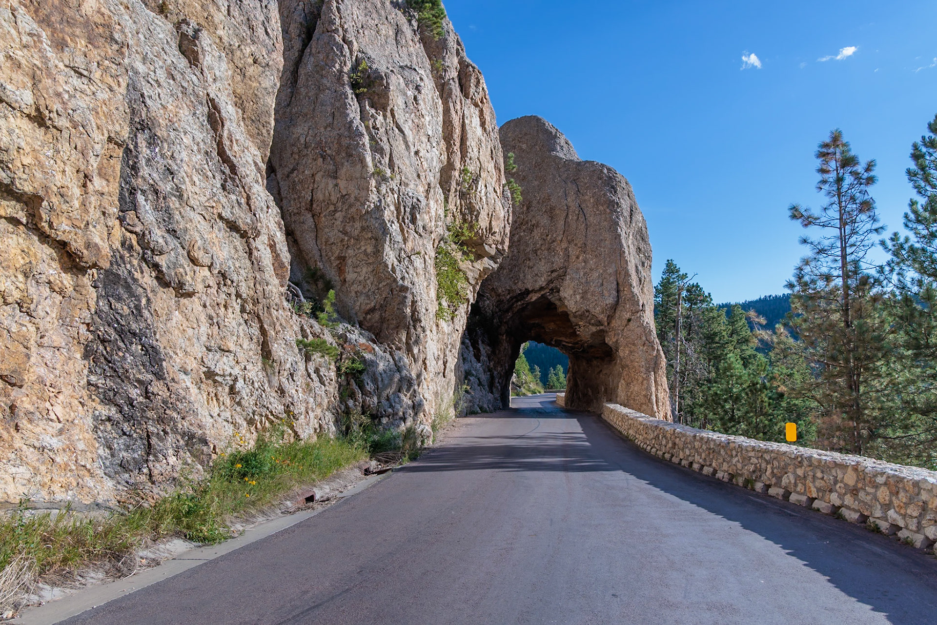 240821_057 Tunnel through rock formation along the road through Custer State Park, South Dakota, USA