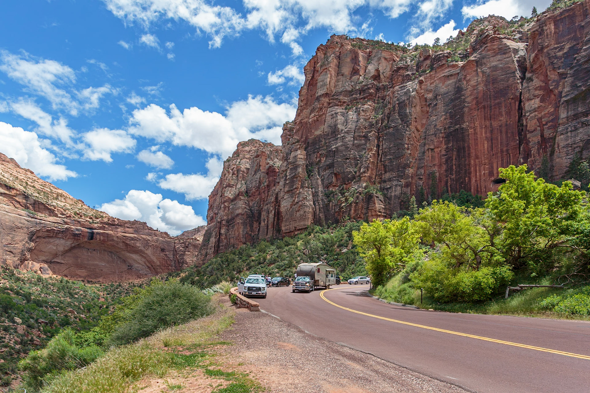 190529_156 Recreational vehicle passes tourists at an overlook next to a blind arch along the Zion Park Boulevard in Zion National Park, Utah
