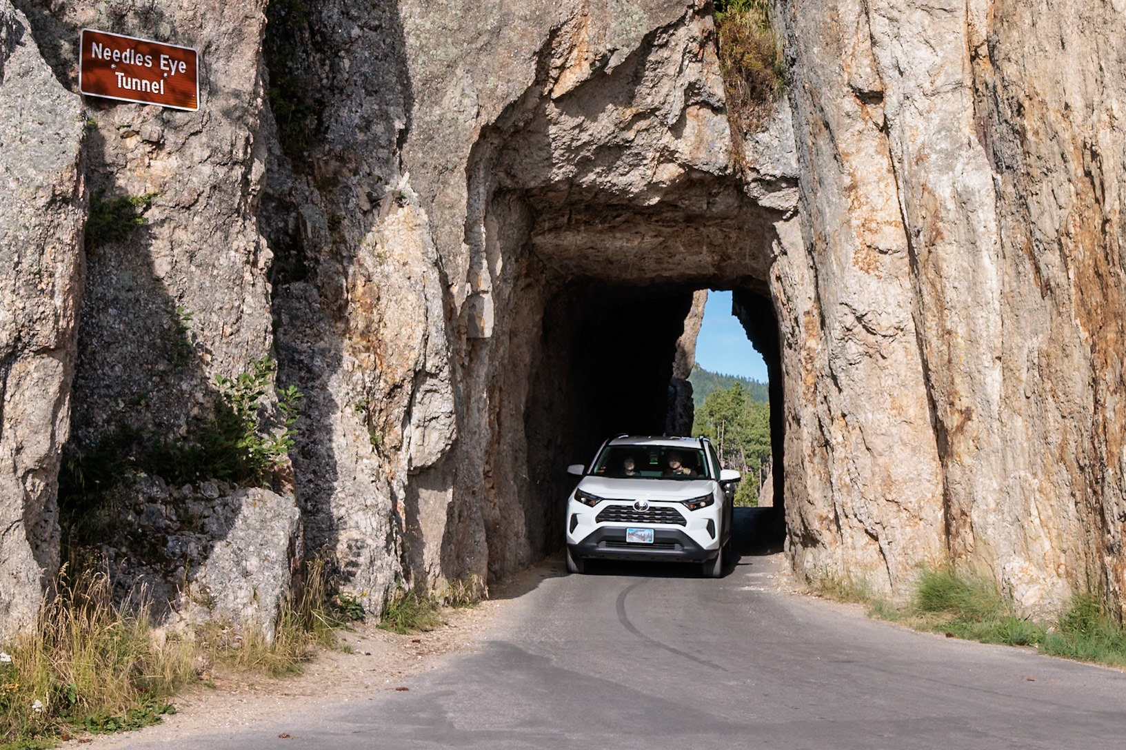 240821_091 SUV exiting the Needles Eye Tunnel in Custer State Park, South Dakota, USA