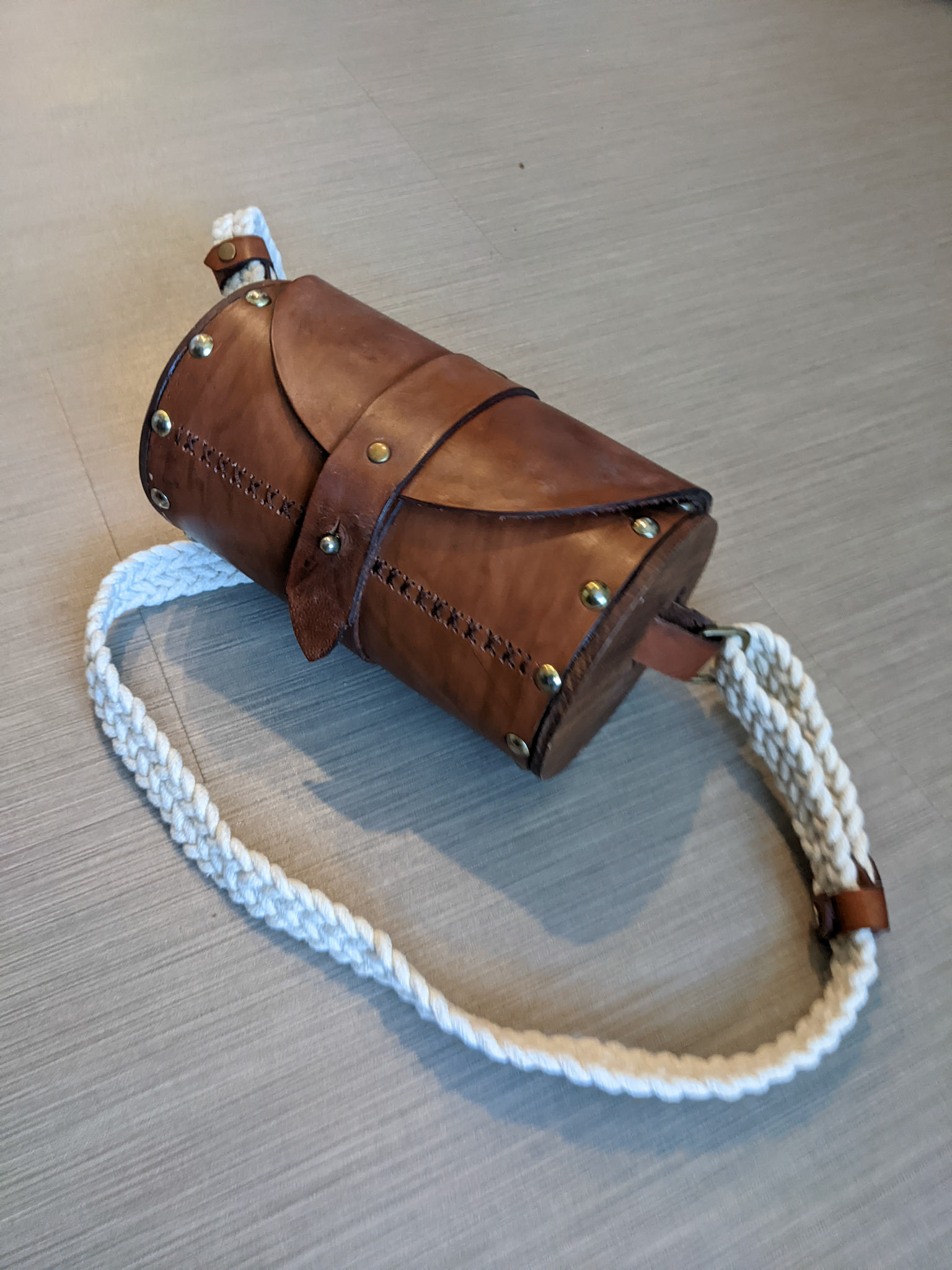 Leather and wood built purse with braided shoulder strap