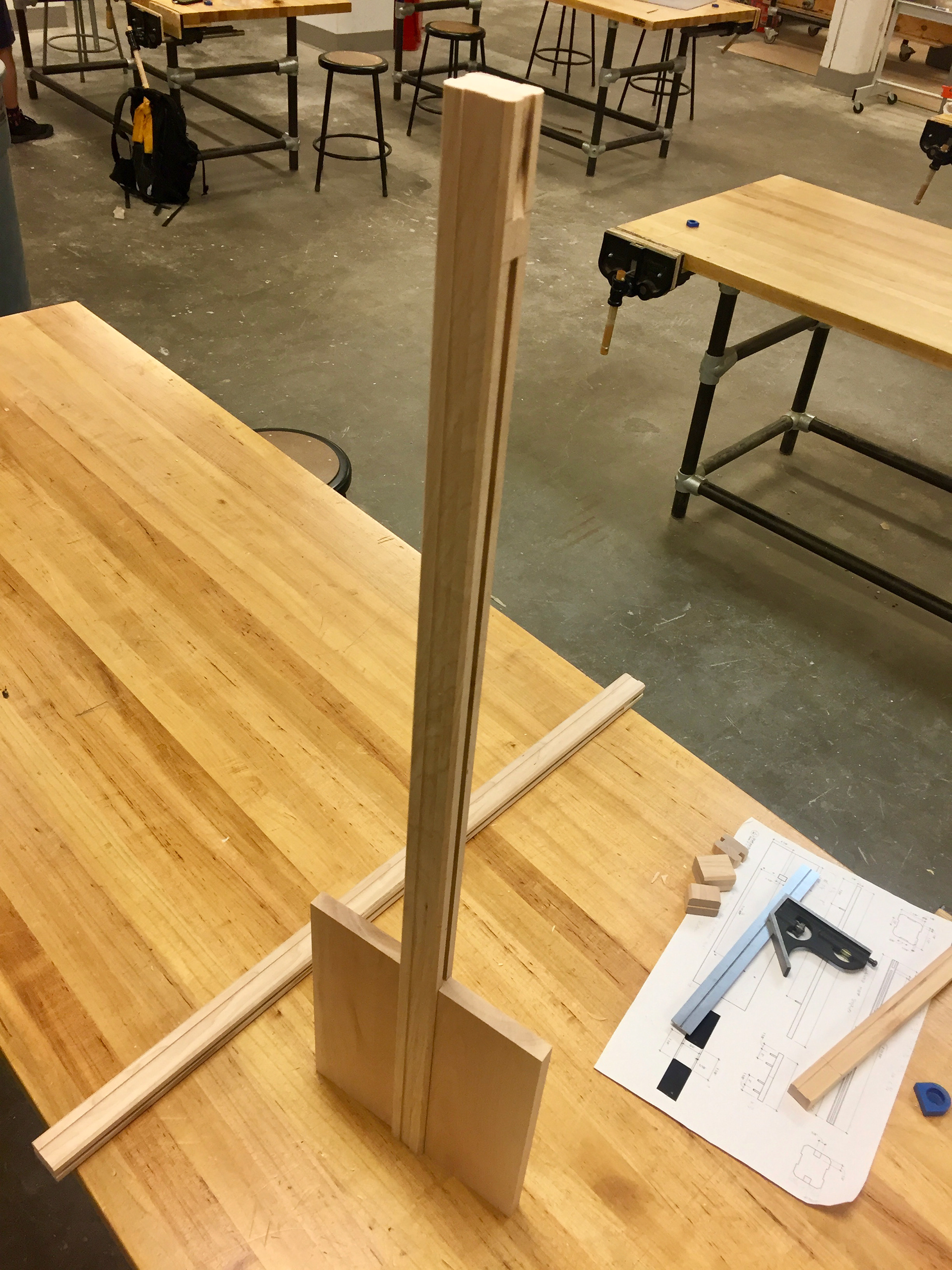 The tenon bar uses a tongue and groove joint to fit vertical boards that support each shelf