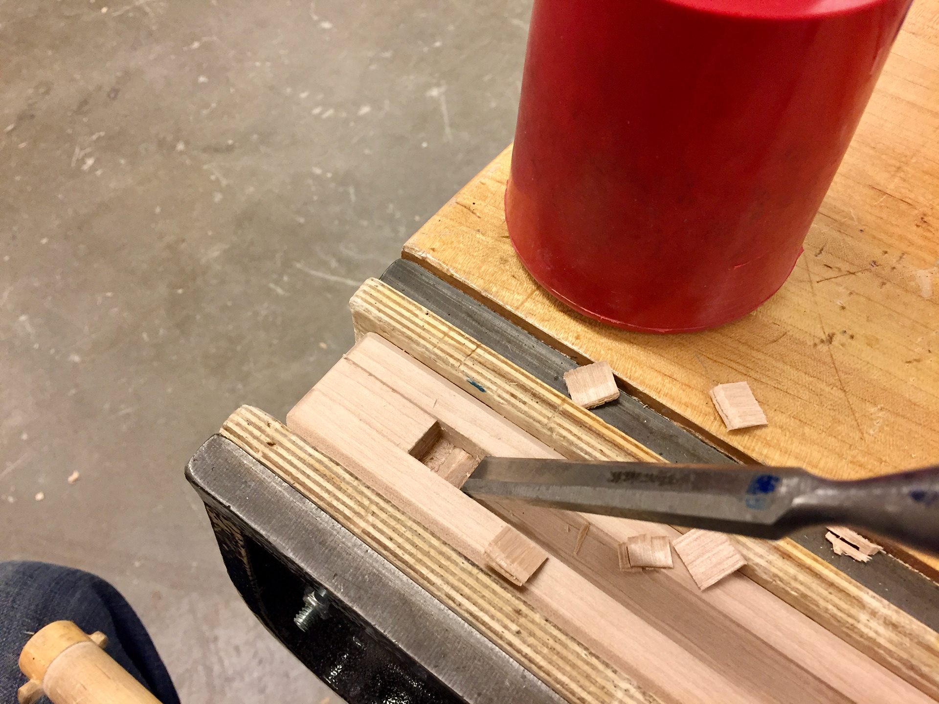 The mortise that will take a wedge to put tension along the tenon bar, compressing the horizontal shelf and vertical boards together