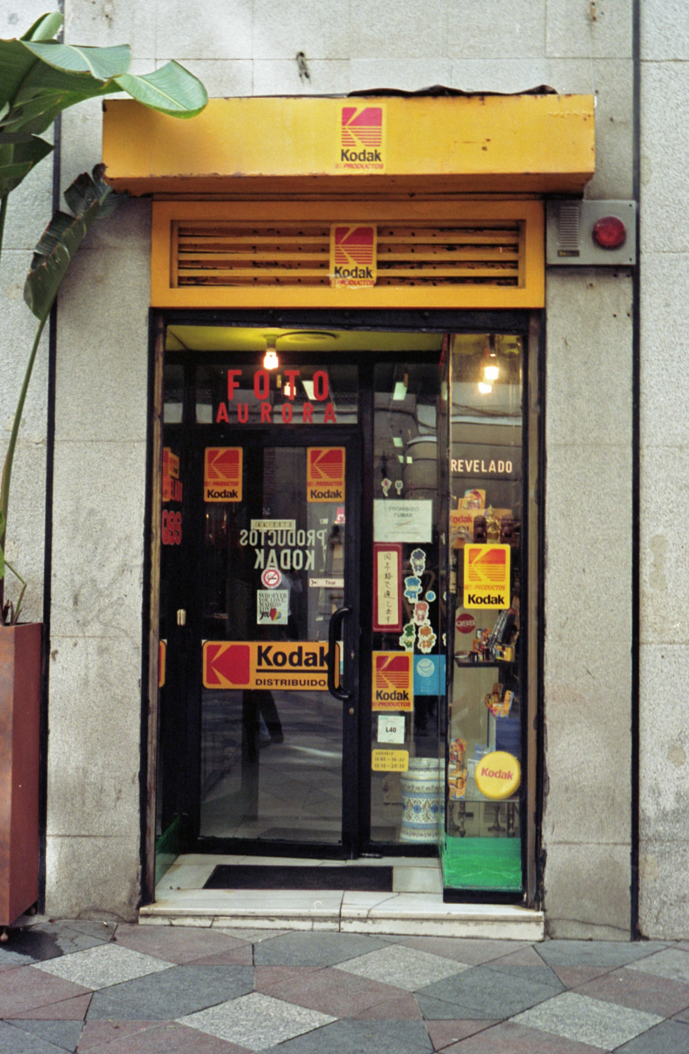 Tiny storefront camera shop with classic Kodak colors