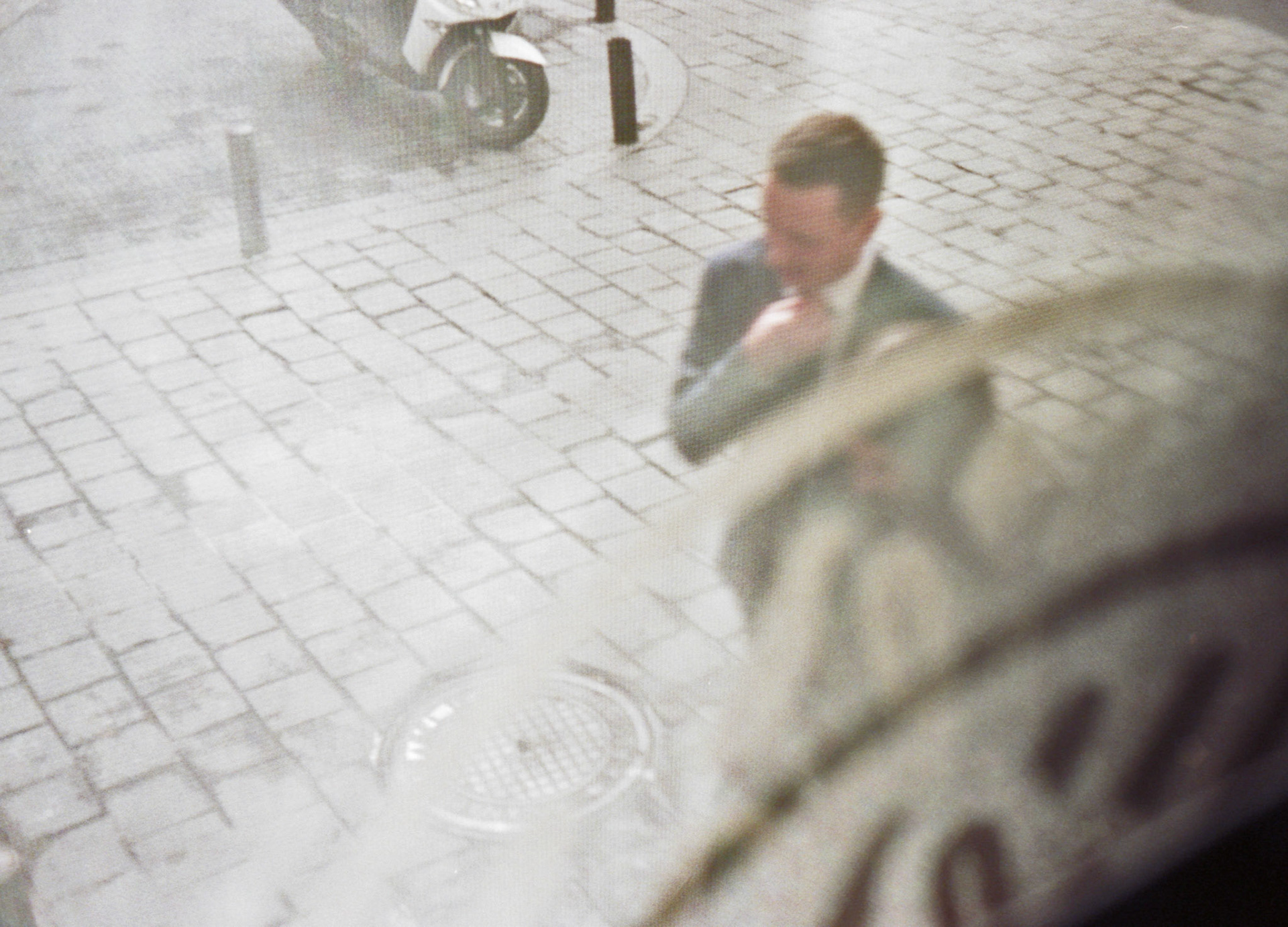 Pedestrian walking past restaurant window.