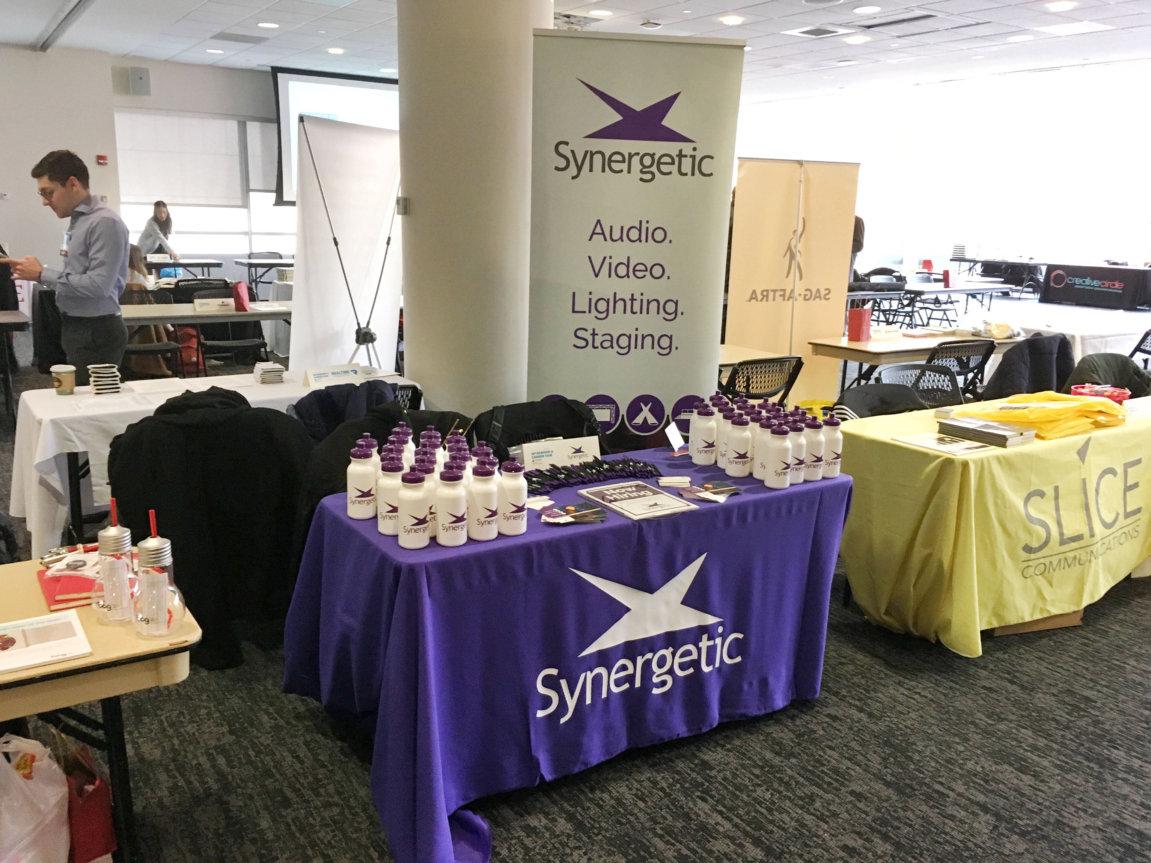 Tablecloth, water bottles, branded pens, and signage for a career fair