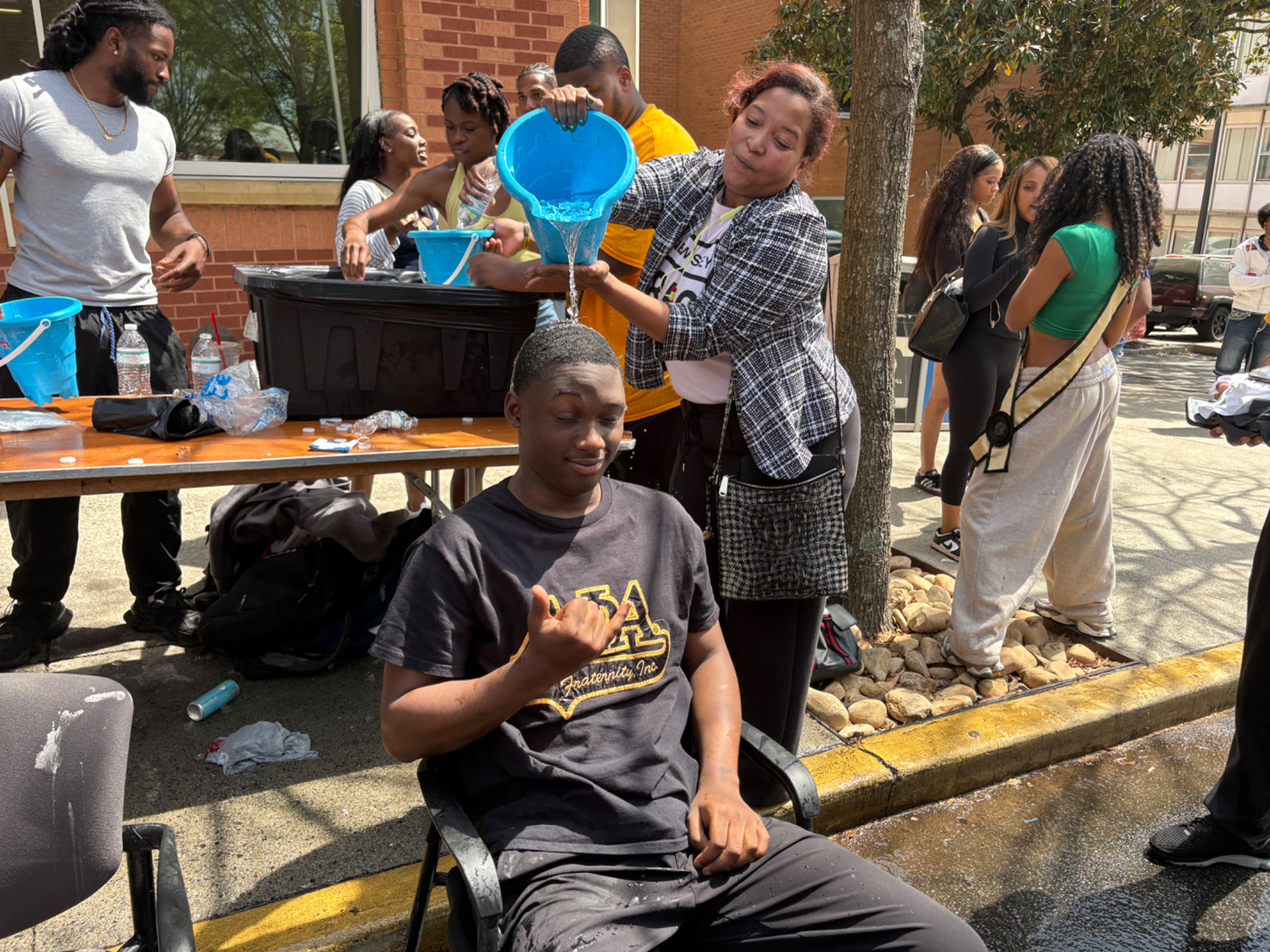 MAN OF THE PEOPLE As one of the more popular request for the "Ice an Alpha" event, Chris prepares to be drenched with a bucket paid for Dean Lovely Durham. (Photo/Noah Cathey)