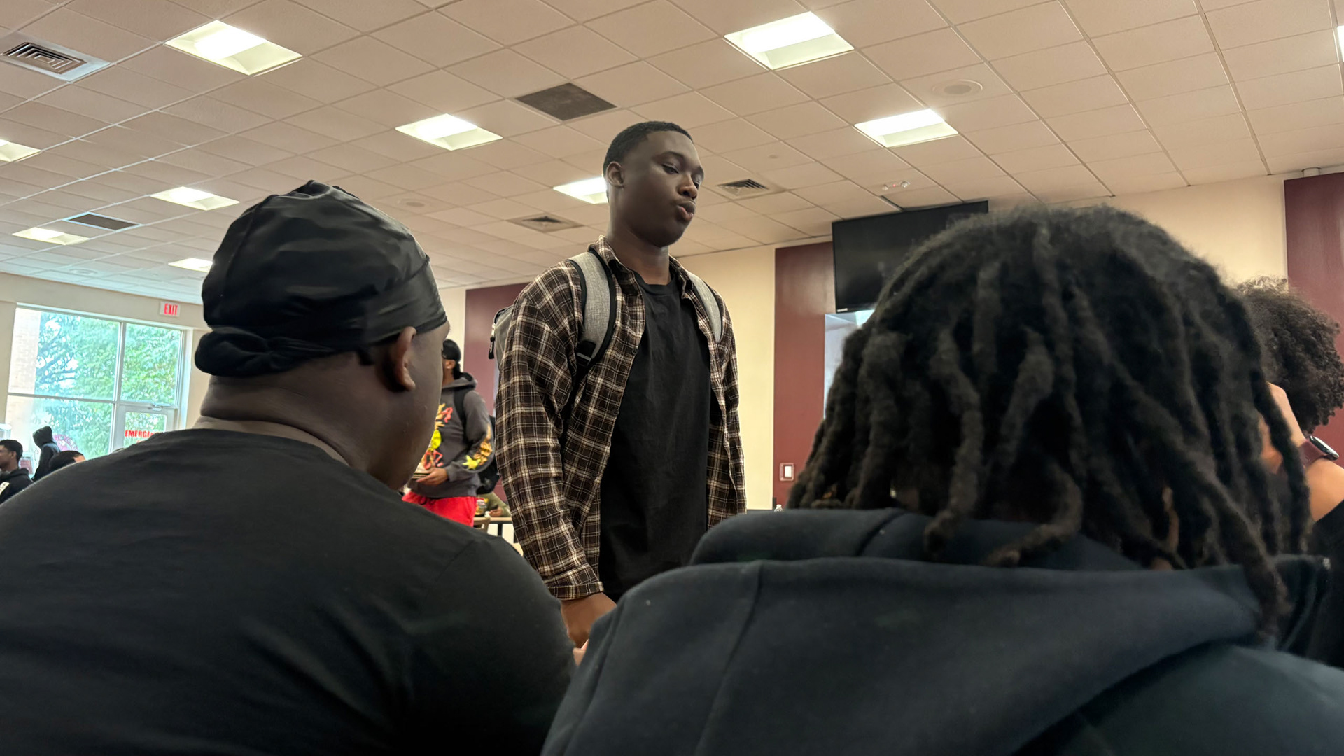 "DON'T MAKE ME CHOOSE" Chris, in his newfound position of social authority, is asked to offer a decisive opinion in an lunch argument between friends. (Photo/Noah Cathey)