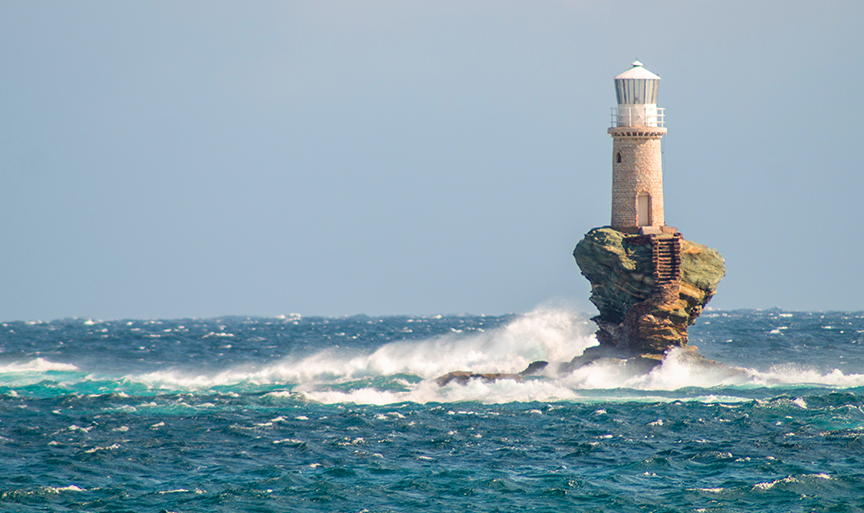 The iconic light house located in Andros, Greece