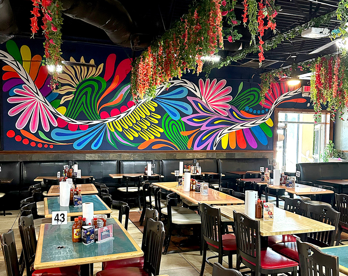 interior mural of colorful mexican inspired design inside mexican seafood restaurant
