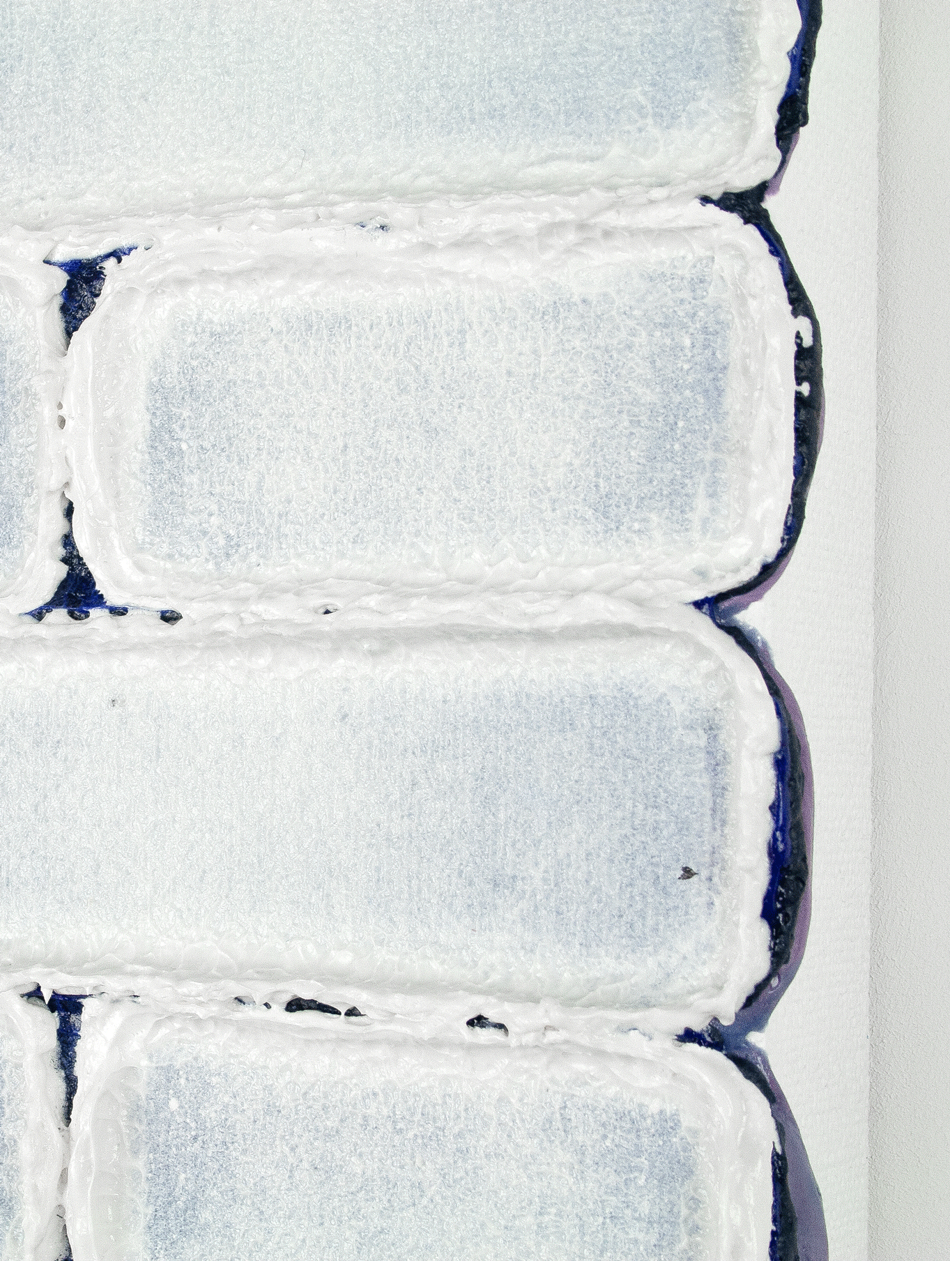 A detail of a striking abstract painting by contemporary Dutch artist Maurice van Venrooij, depicting a grid-like pattern of soft blue rectangular shapes with thick white textured borders against a deep navy background. The painting’s tactile surface and structured composition reflect Van Venrooij’s signature abstract style.