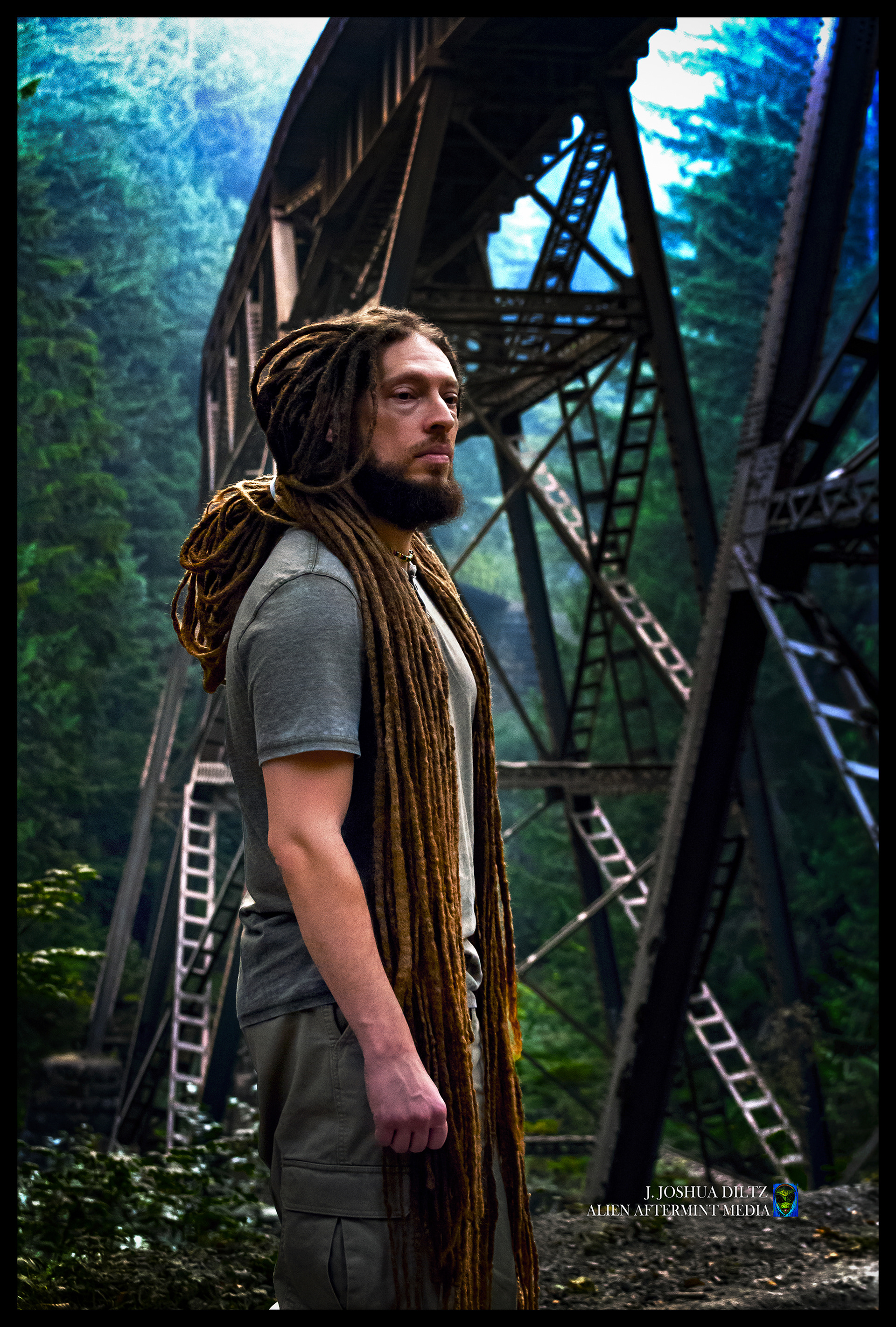 Singer/Songwriter Jay Canter of the reggae band Street Level Uprising stands beside an iconic bridge scene while visiting the Pacific Northwest.  Photo by J. Joshua Diltz.  Alien Aftermint.