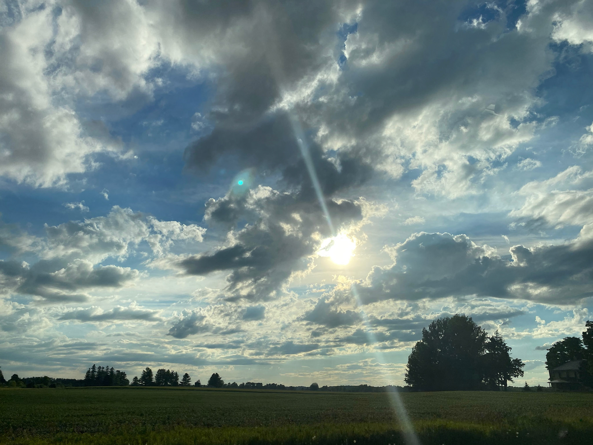 Sun and clouds and sunset during ride to the cottage - July 28-2022