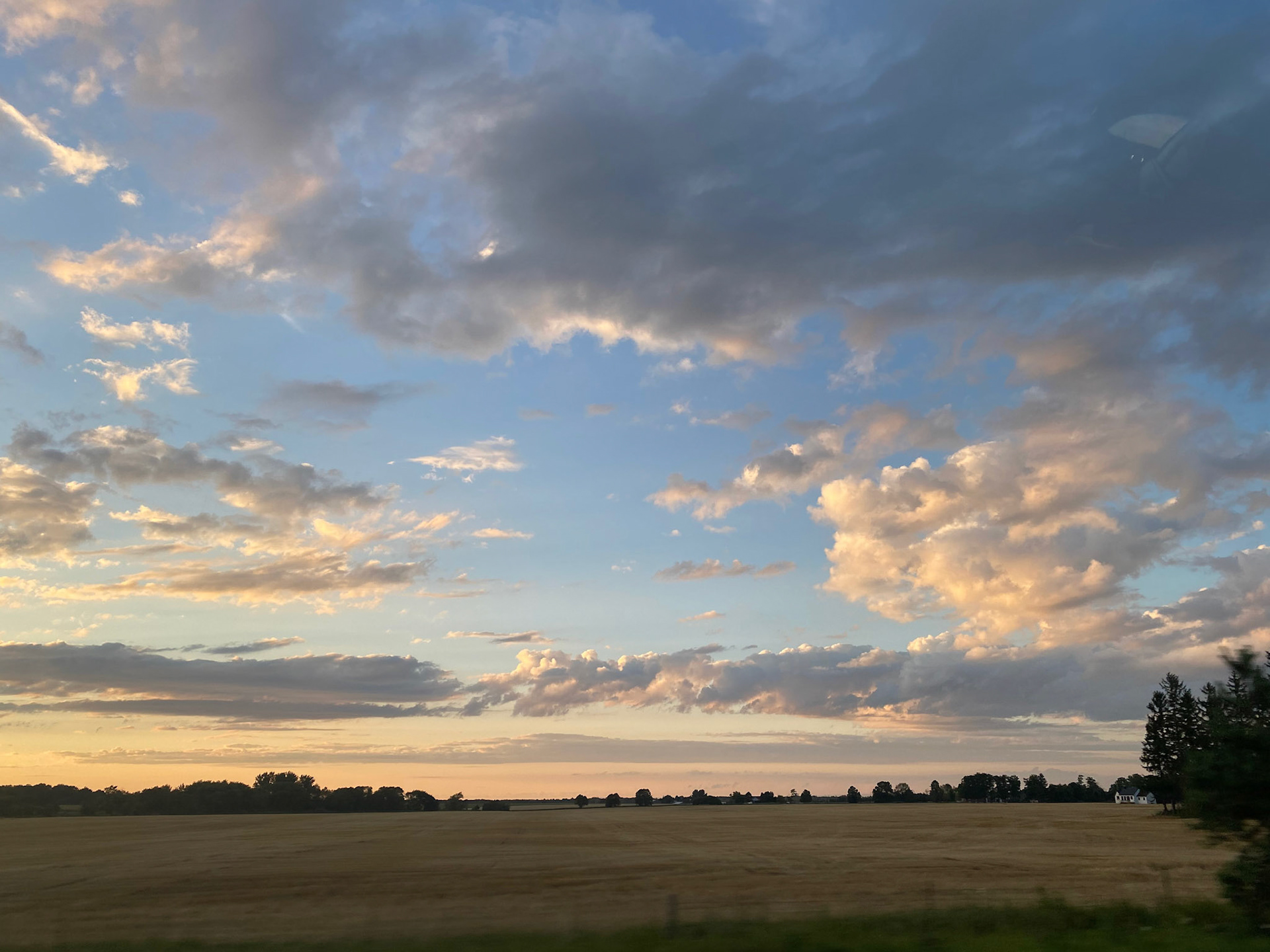 Sun and clouds and sunset during ride to the cottage - July 28-2022