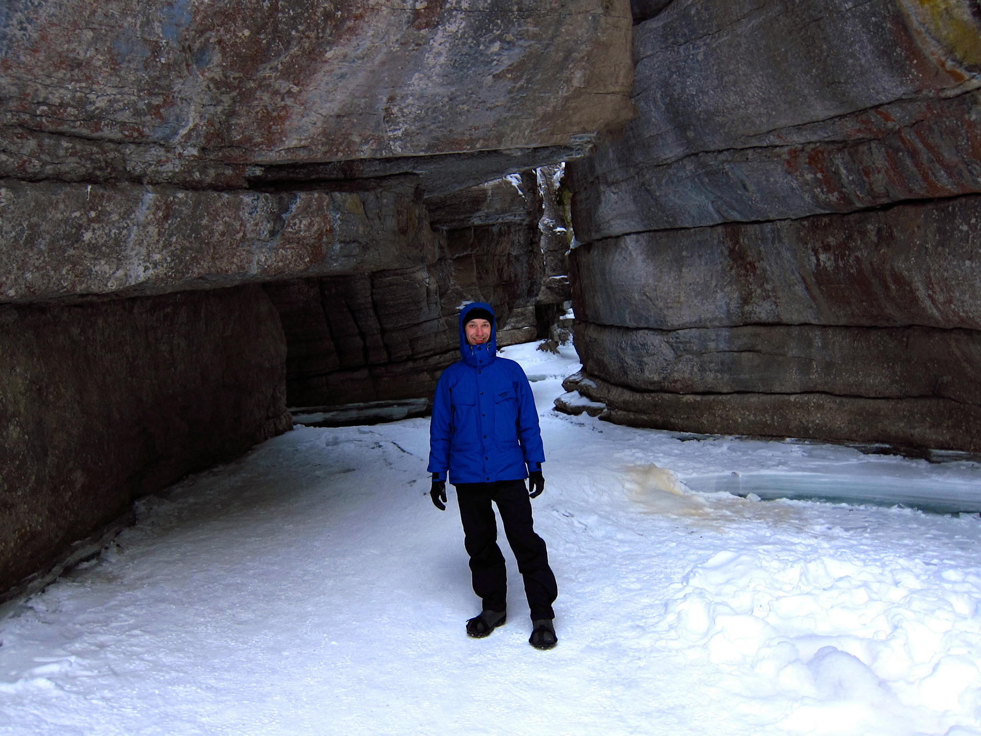 Standing on the ice of the frozen river in Maligne Canyon